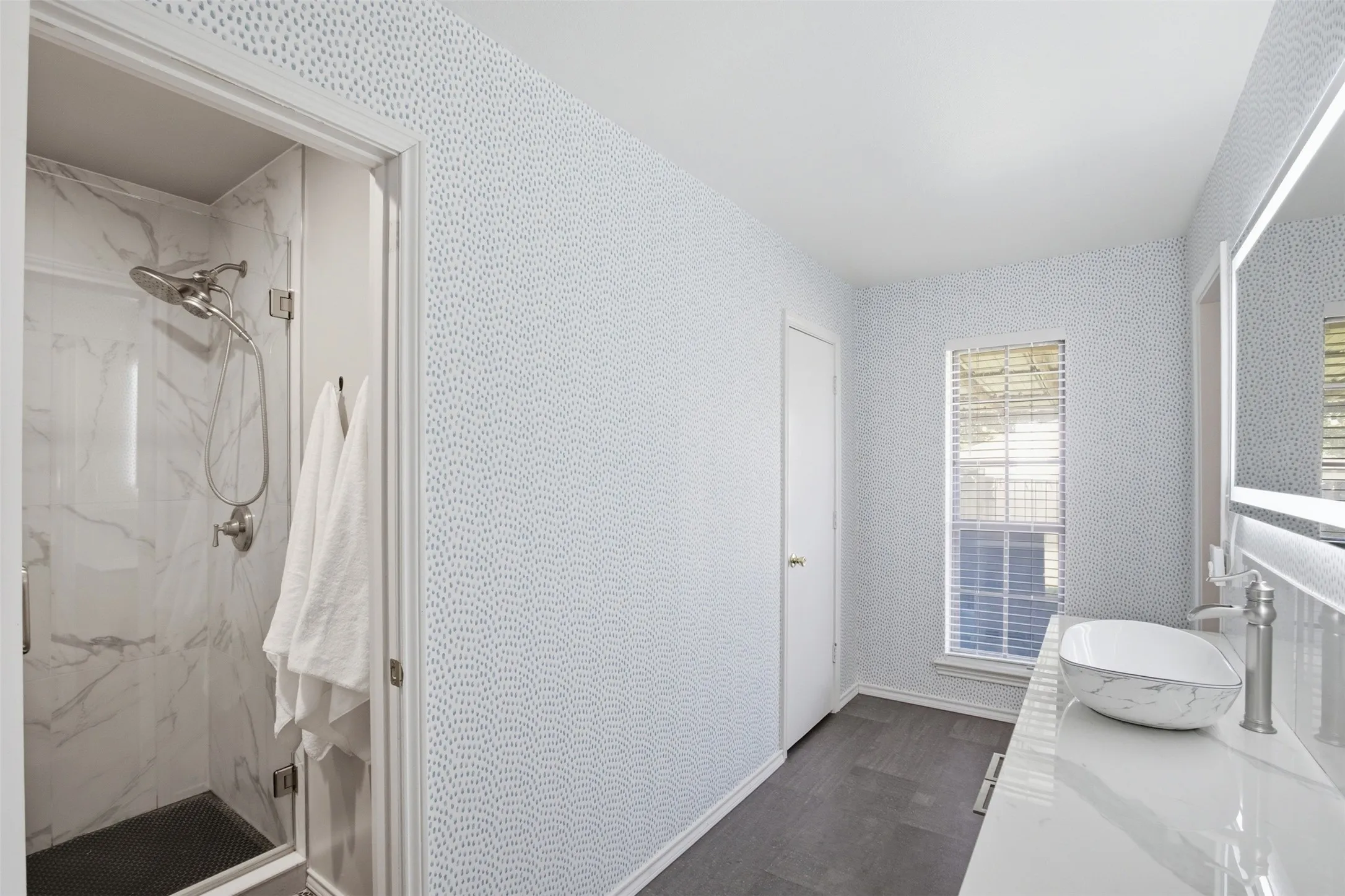 Another view of the primary bathroom, complete with an additional walk-in closet.