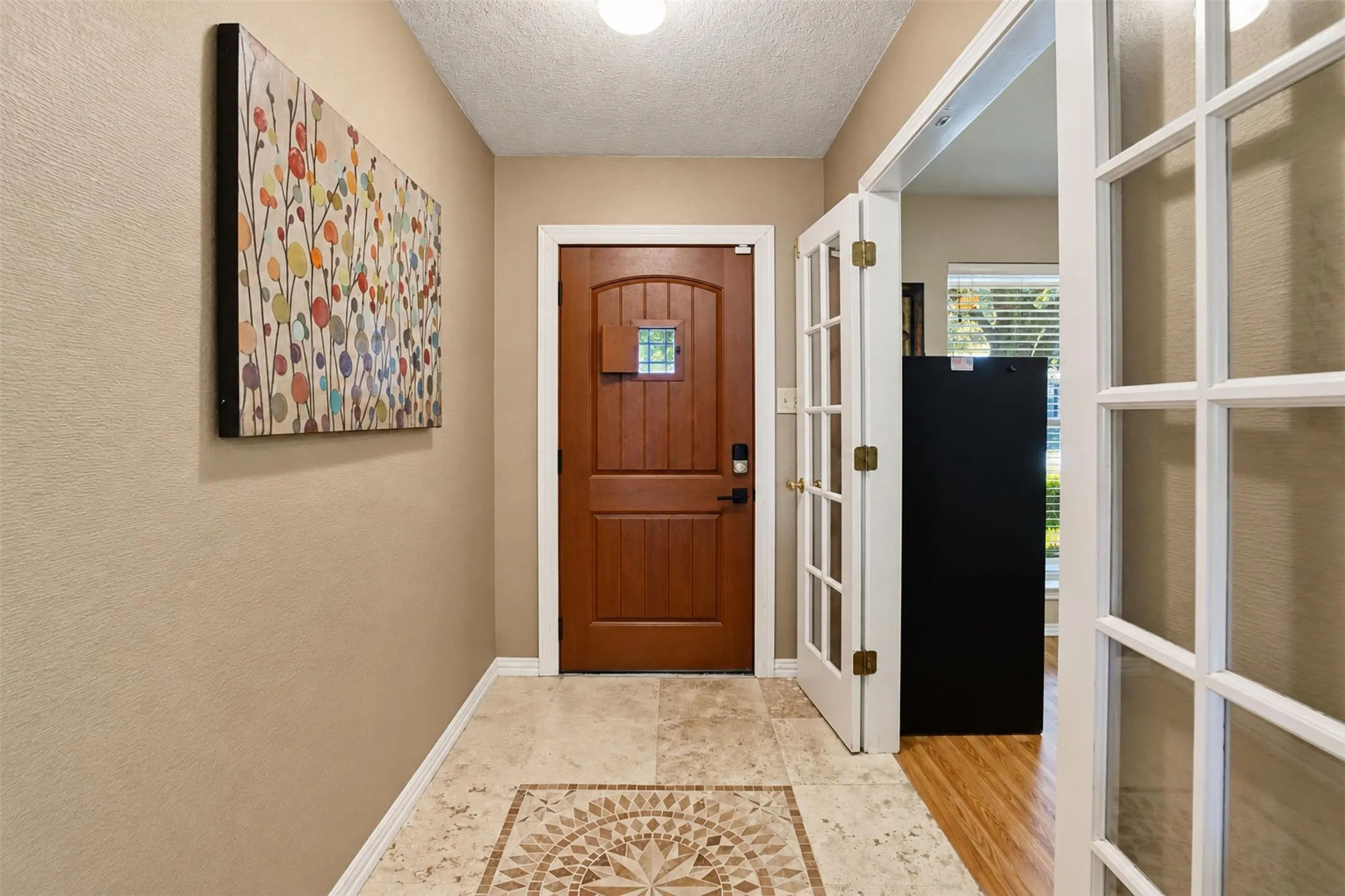 Another look at the inviting entry, with French doors opening to the versatile front room.