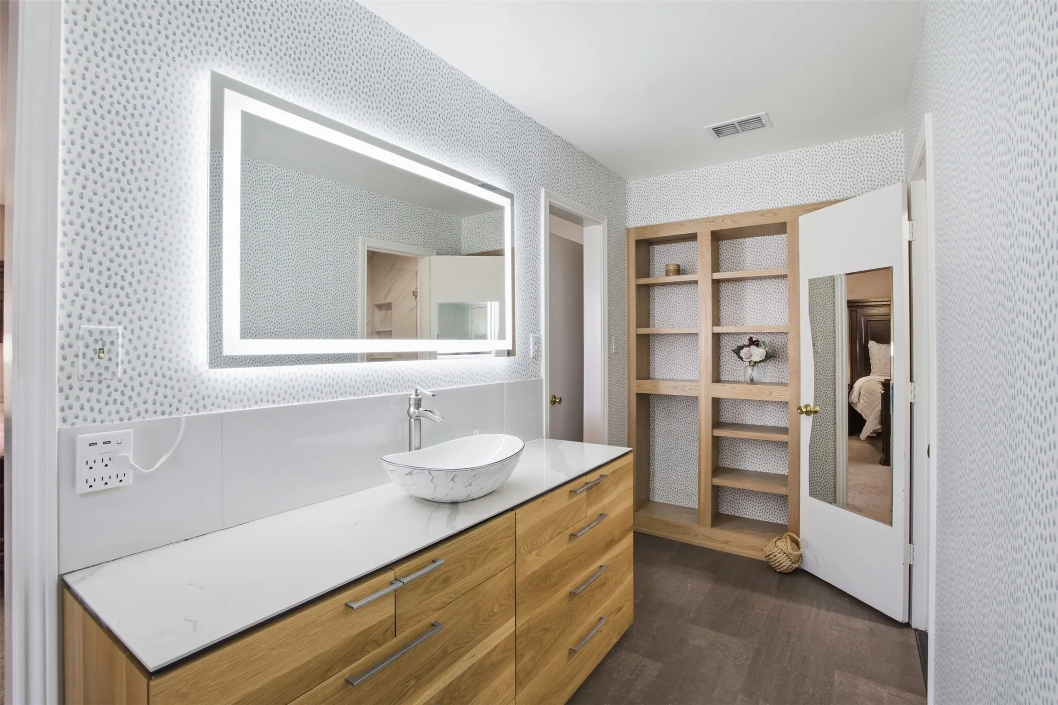 The updated primary bathroom offers a fresh, timeless feel and everyday functionality.