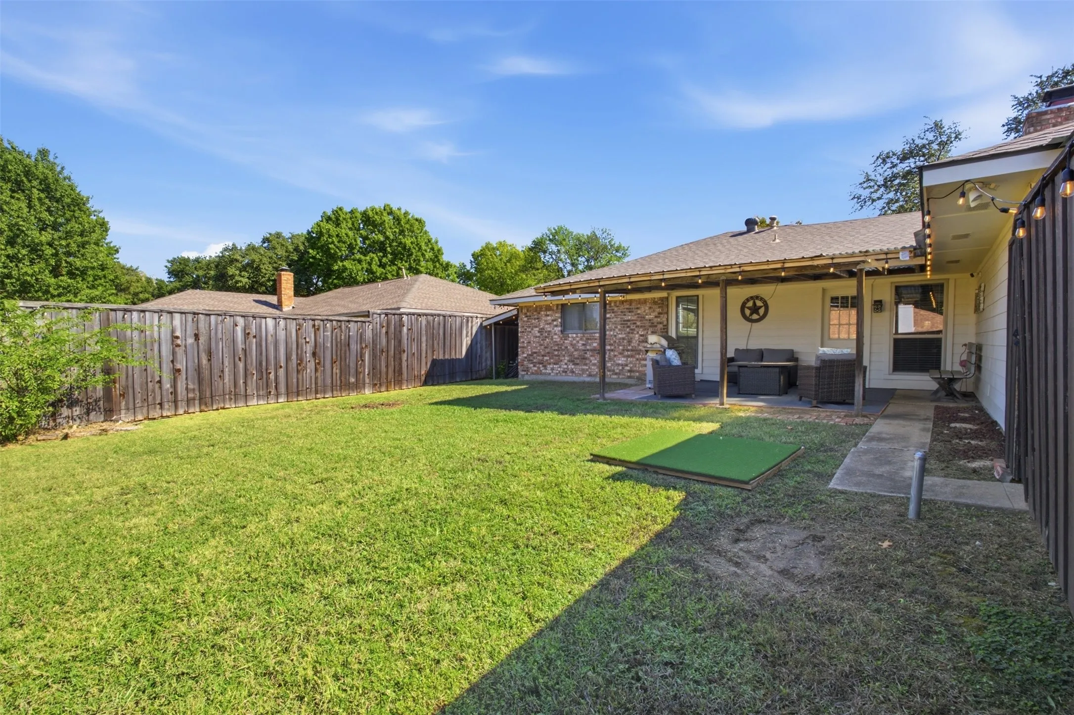 A welcoming backyard with a covered patio, ready for outdoor gatherings or quiet afternoons.