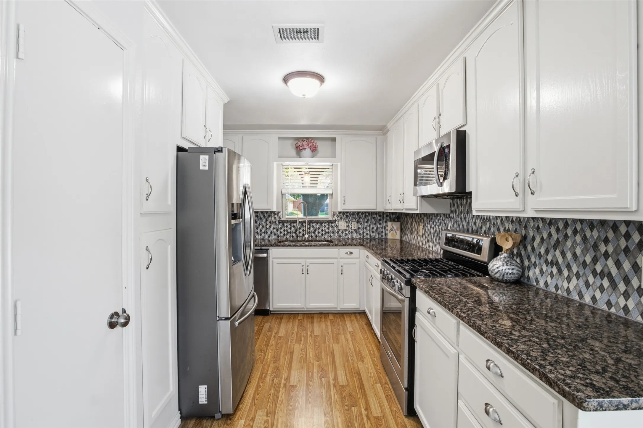 The heart of the home! An updated kitchen with crisp white cabinetry and contrasting countertops.