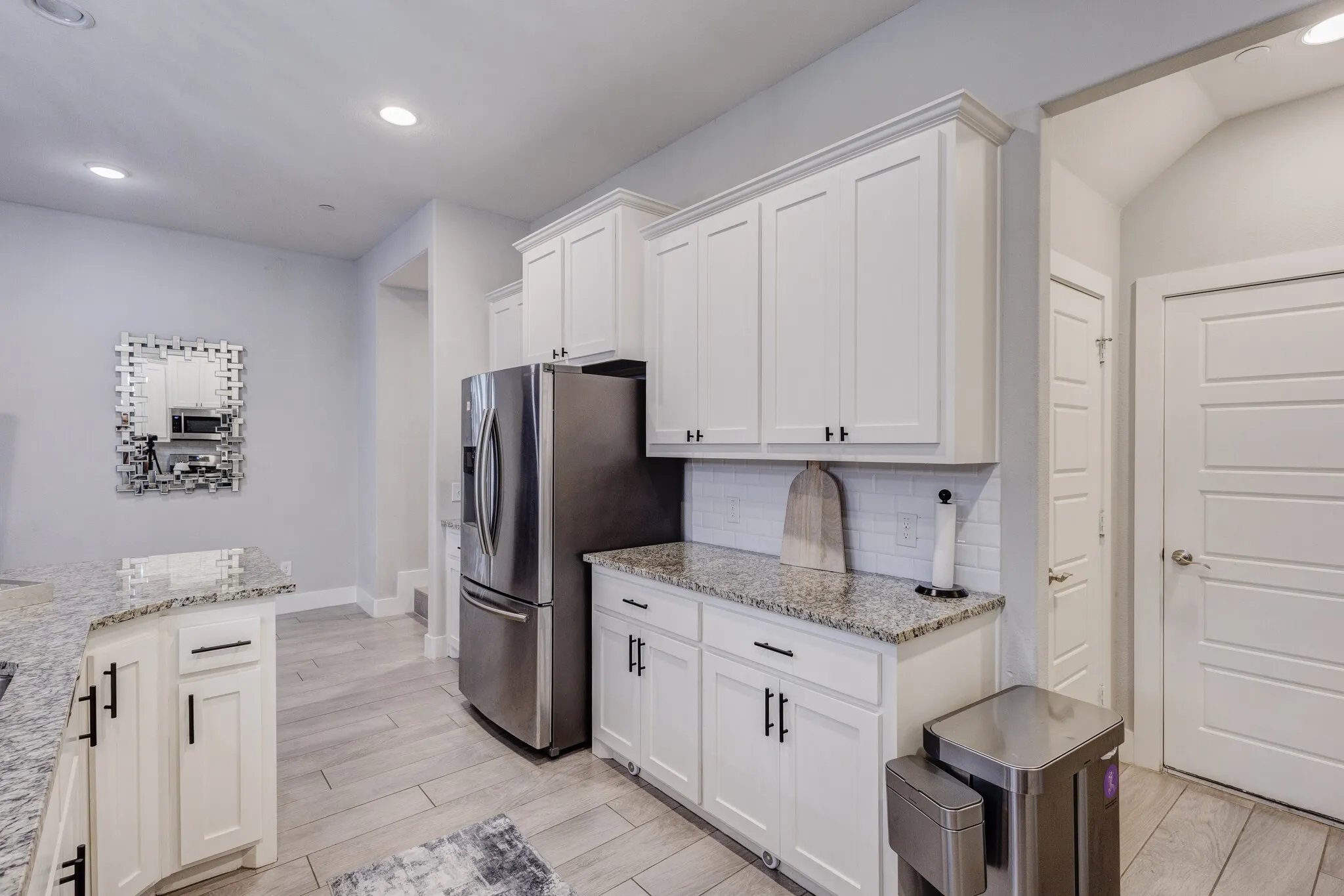 White shaker cabinetry with dark hardware