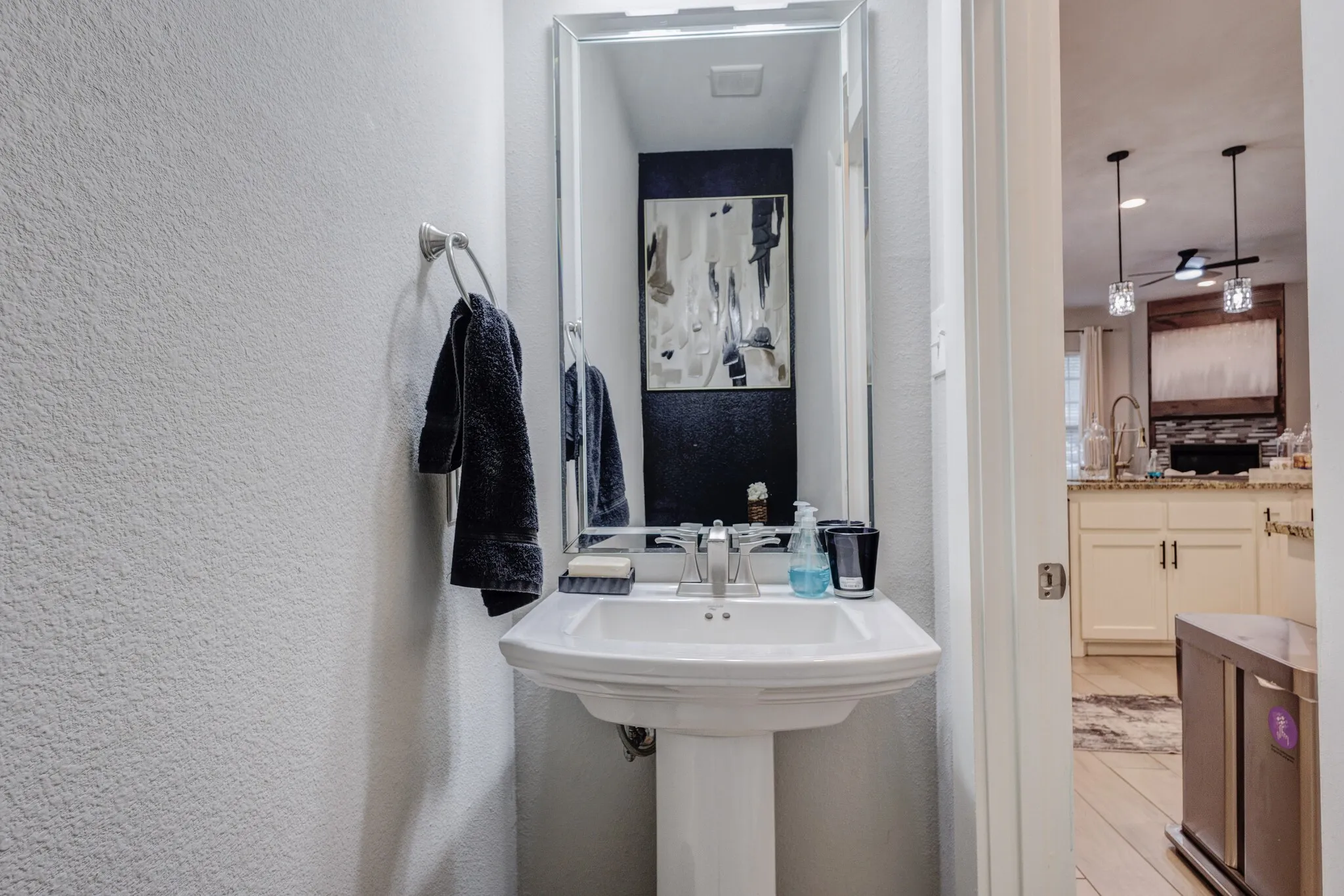 Pedestal sink with a polished chrome faucet