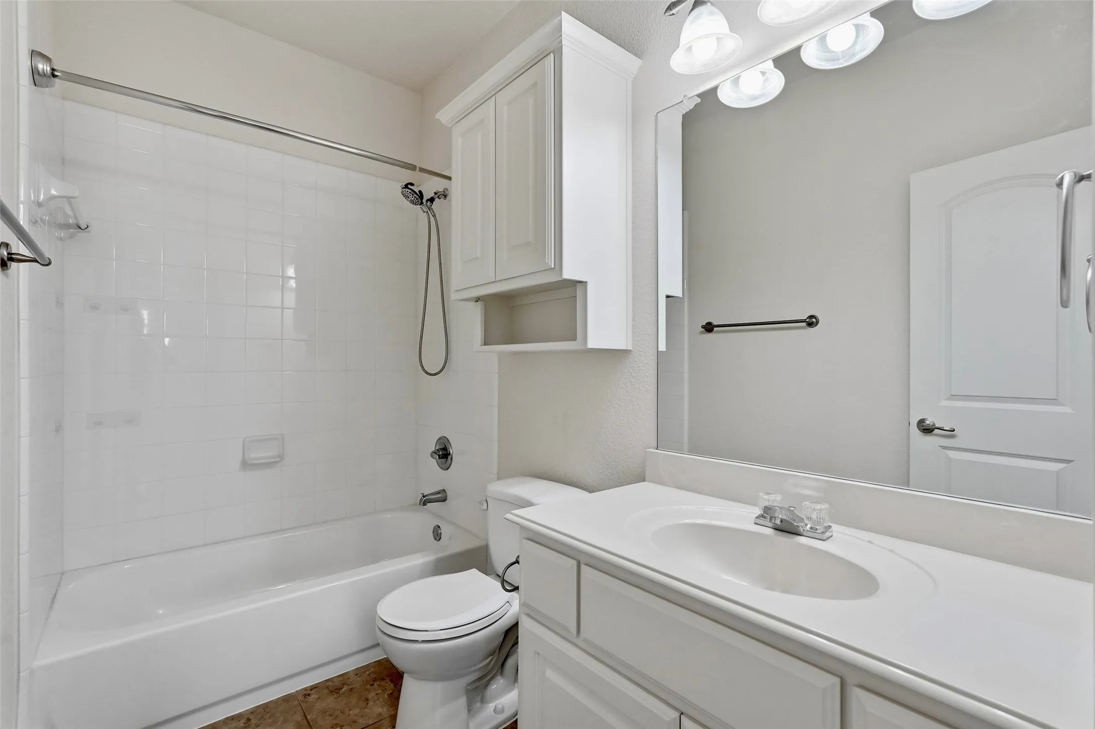 White tiled shower-over-tub combination with a chrome shower fixture