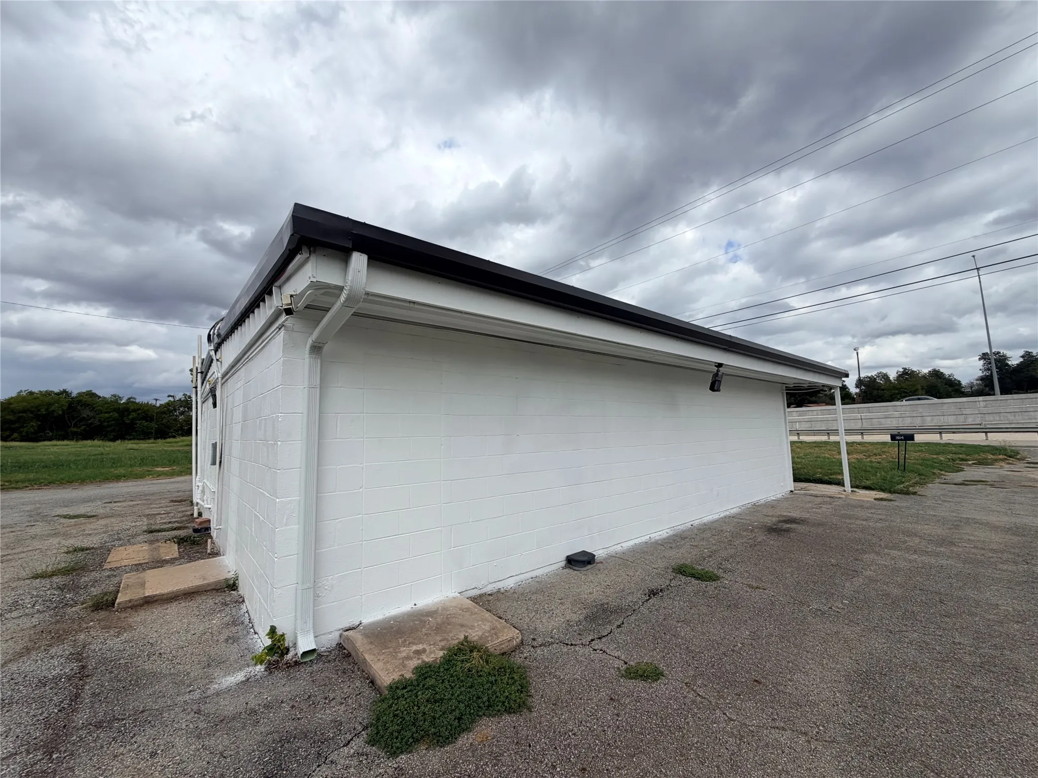 White painted block exterior with black trim and white gutters