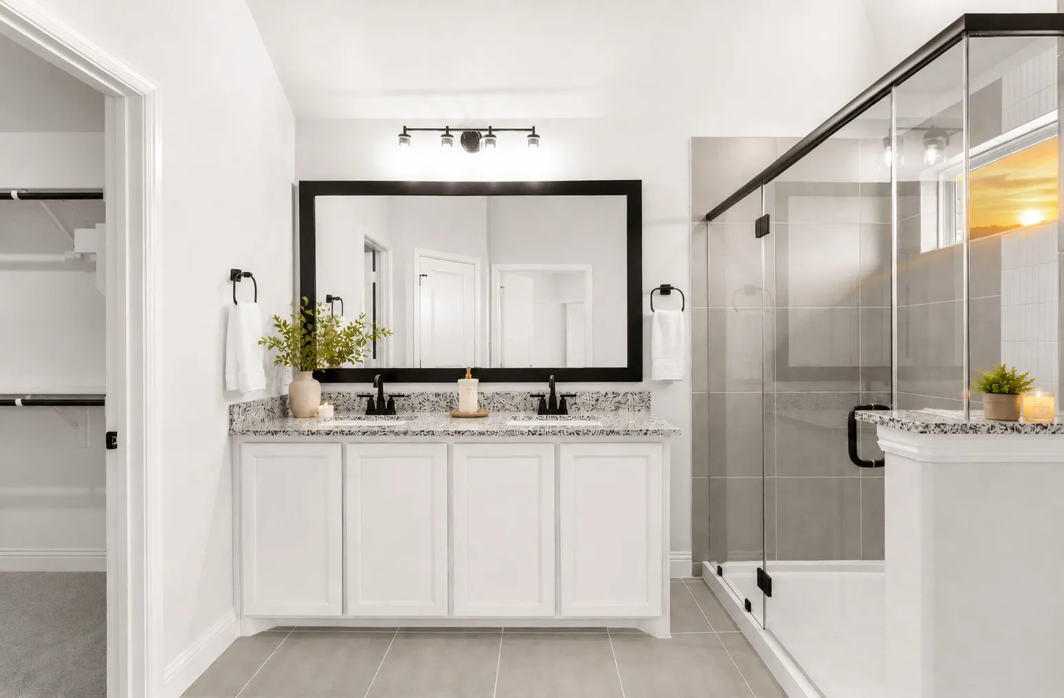 Dual vanity with white cabinetry and stone countertops