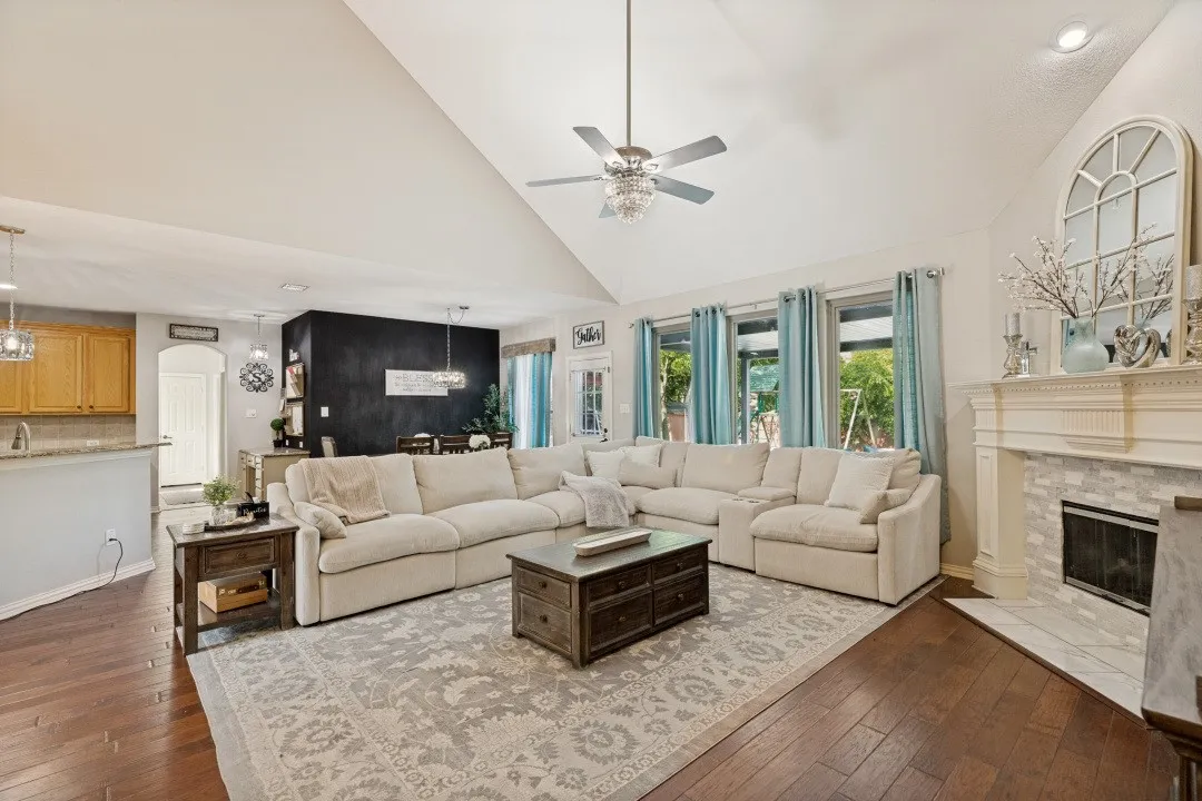 Expansive windows frame beautiful views of the private backyard oasis, seamlessly blending indoor and outdoor living.