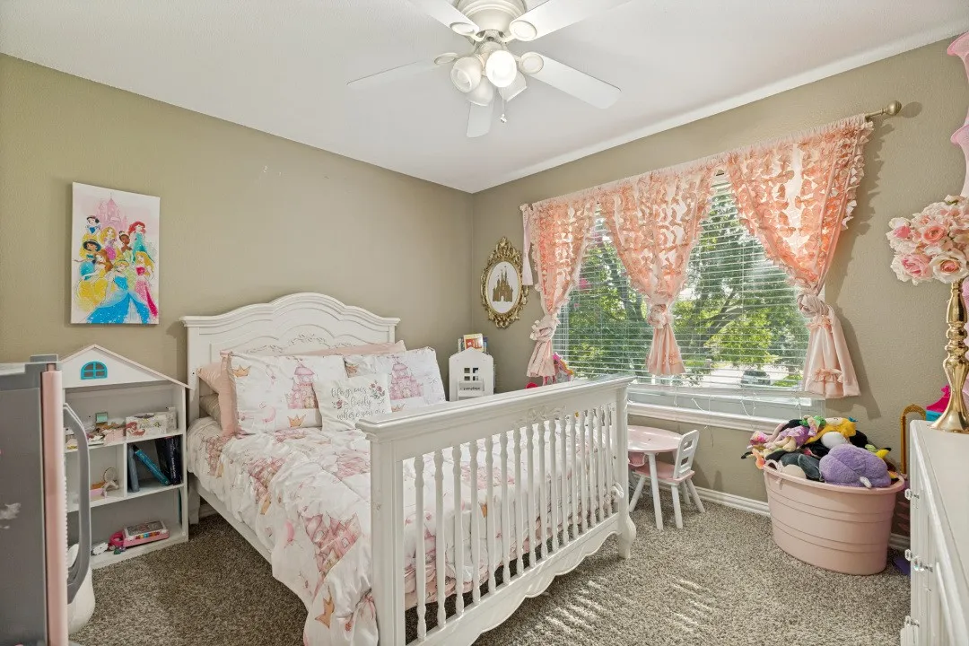 Bright upstairs secondary bedroom offering generous closet space and natural light.