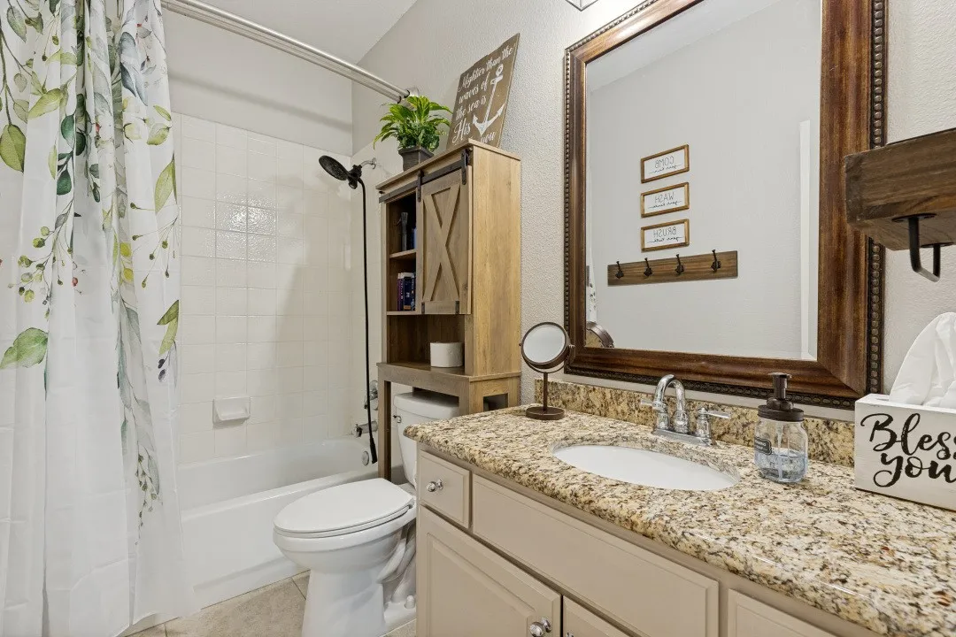 Convenient full bathroom located on the main level, serving guests and the downstairs bedroom.