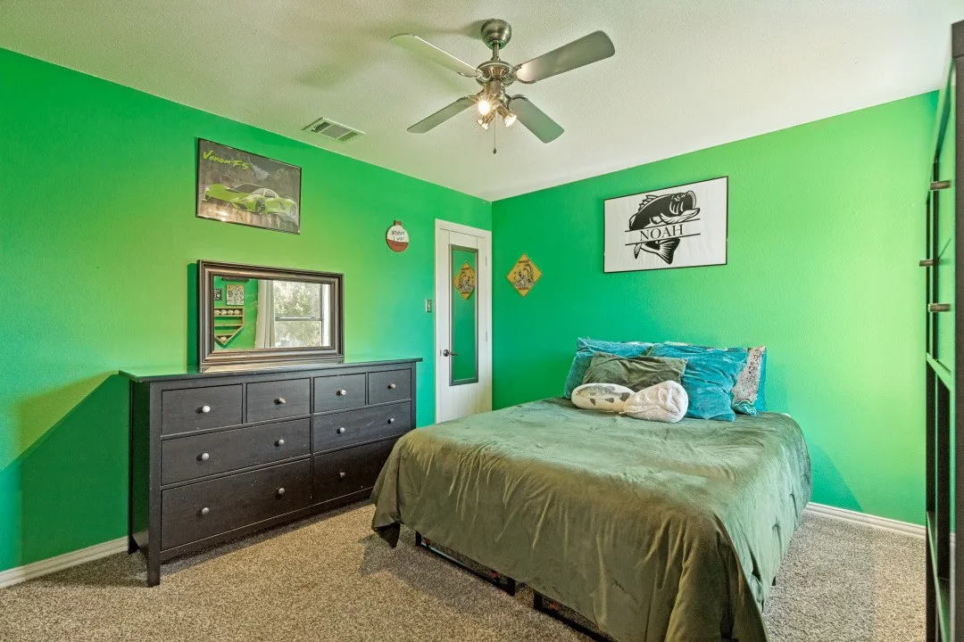 Spacious upstairs bedroom with versatility for family, guests, or a hobby room.