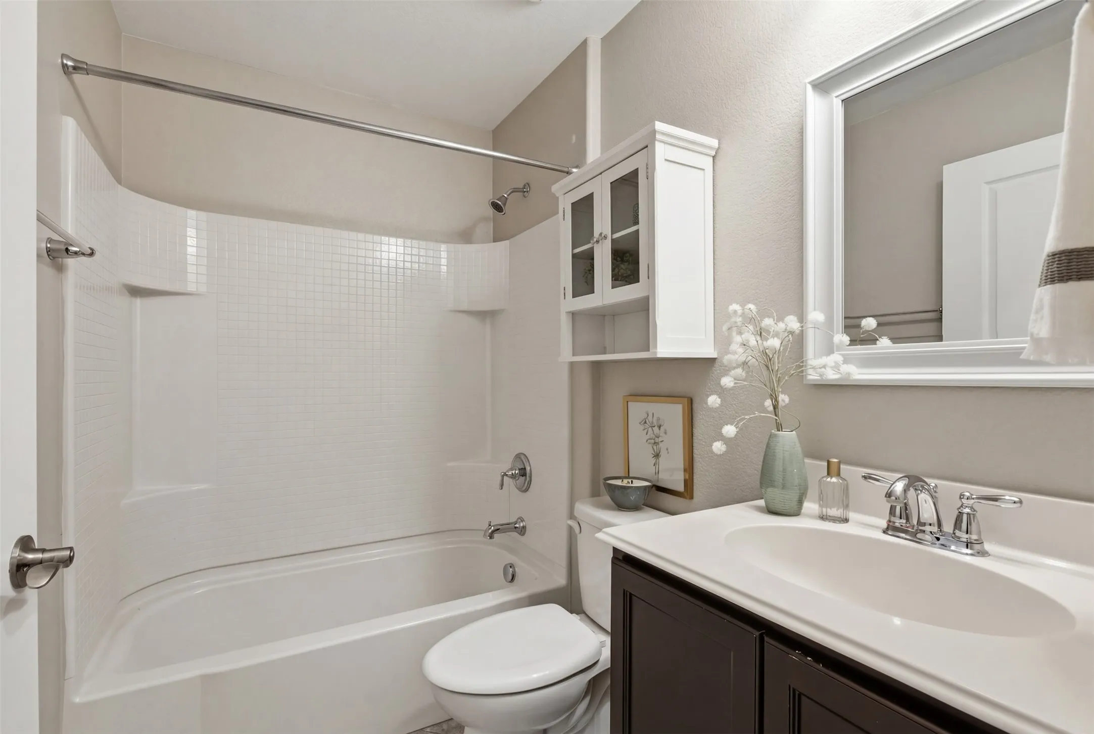 Integral tub and shower combination with a curved shower curtain rod
