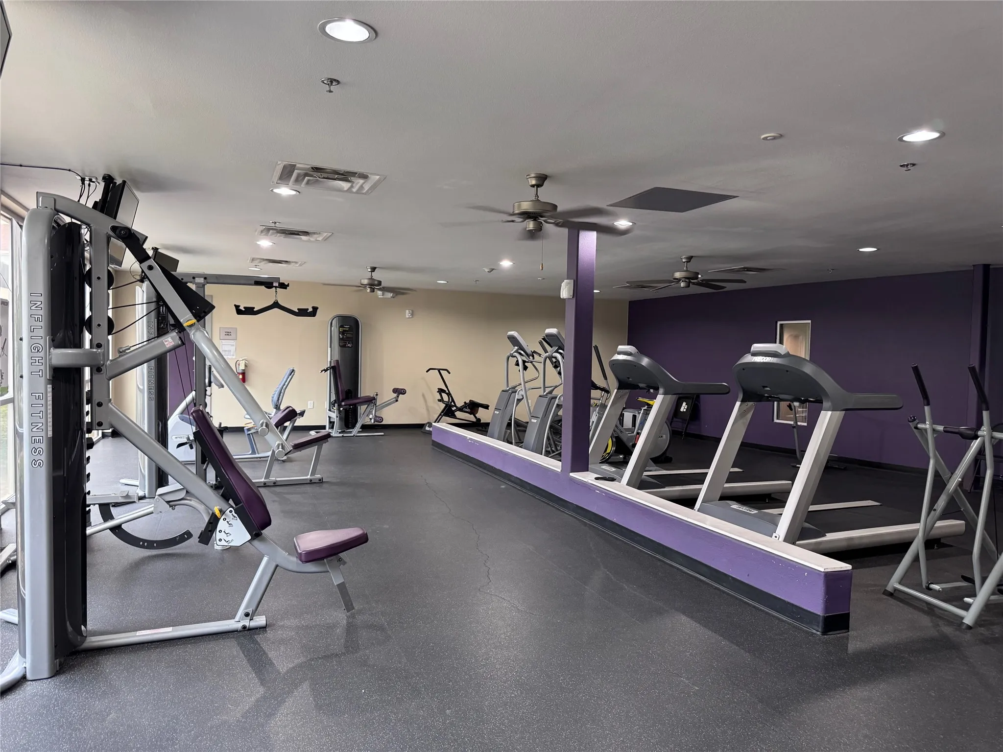 Fitness center with rubber flooring, recessed lighting, and ceiling fans