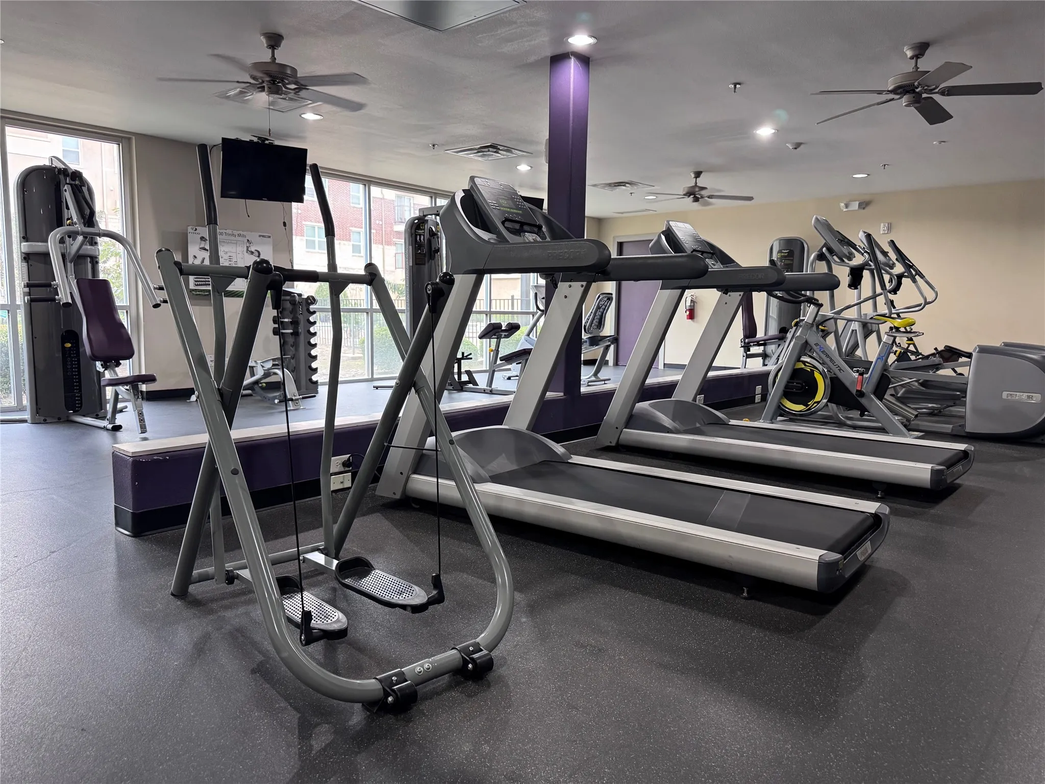 Fitness center with rubberized flooring, ceiling fans, recessed lighting, and wall-mounted television