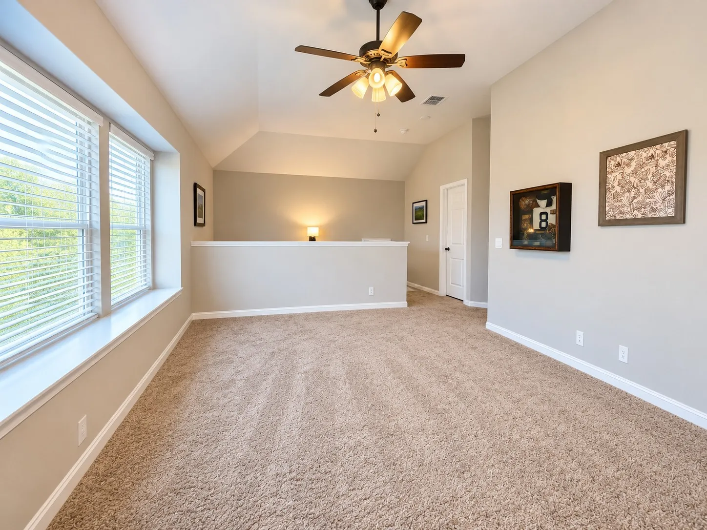 Neutral-toned walls complement the plush carpet flooring