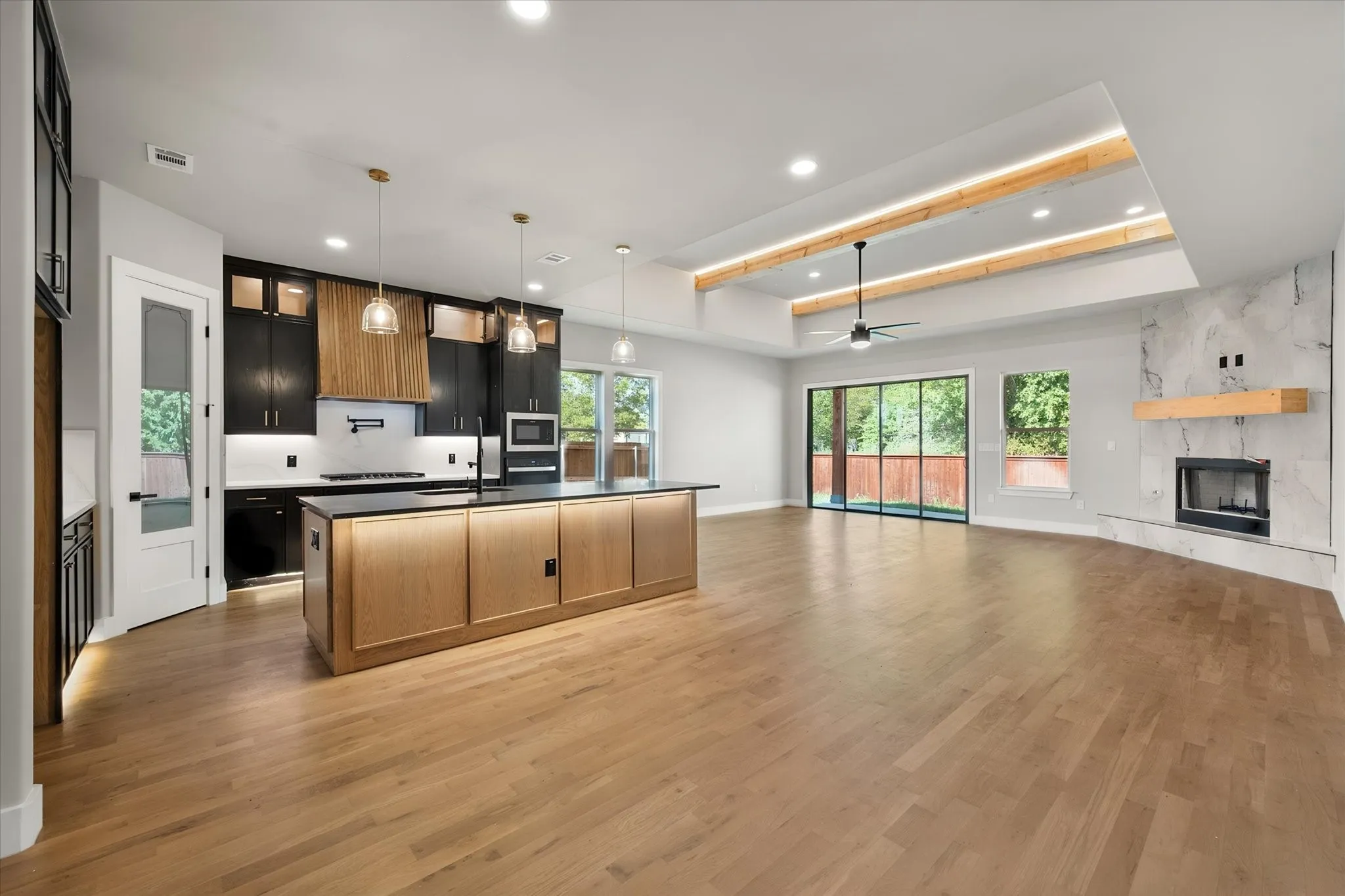 Open-concept living space with wood-finish flooring