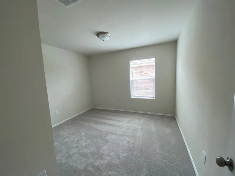 Neutral-toned walls complement plush carpeting