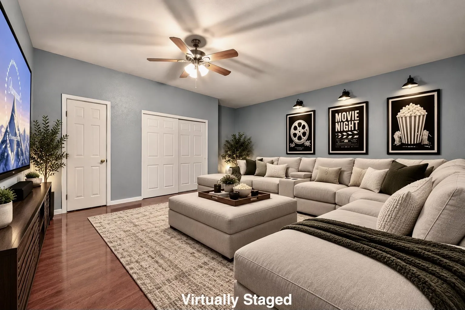 Wood-finish flooring, ceiling fan with integrated lighting, wall-mounted accent lighting, and bi-fold closet doors