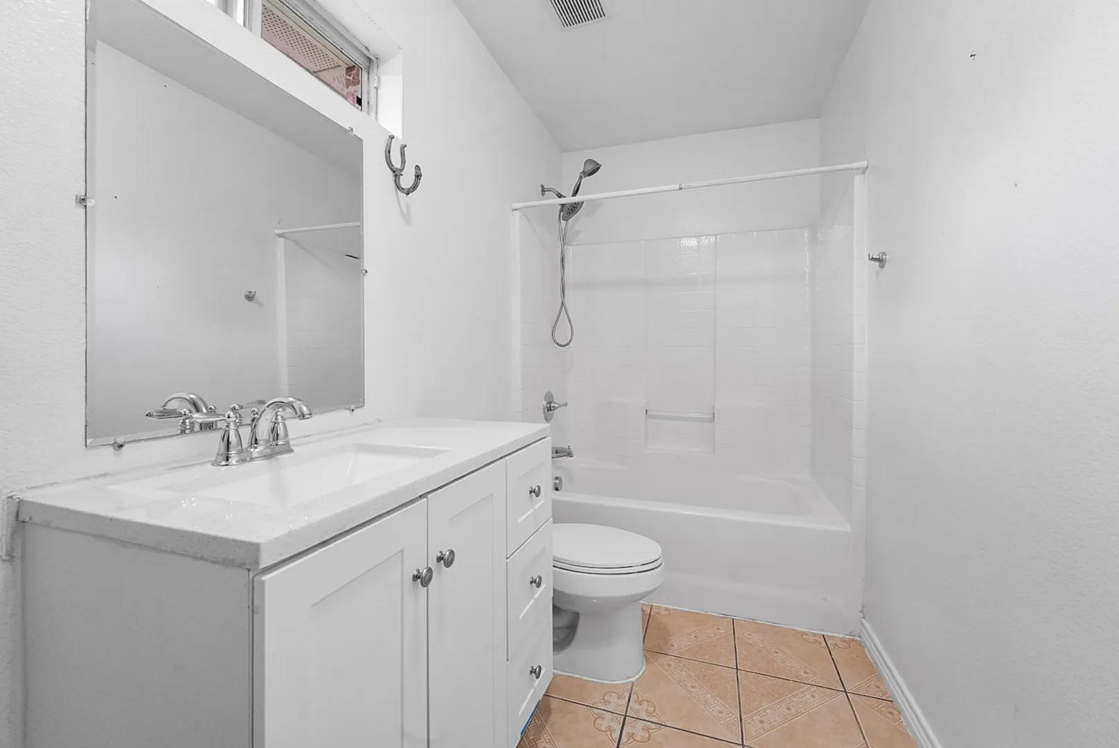 White vanity with a single basin sink and chrome faucet