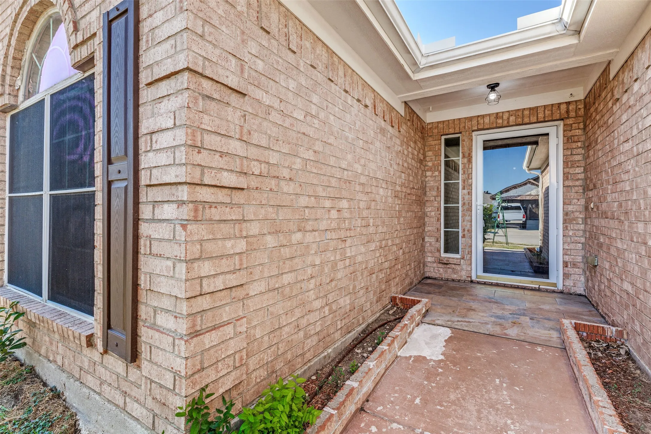 Brick exterior facade with a covered entry