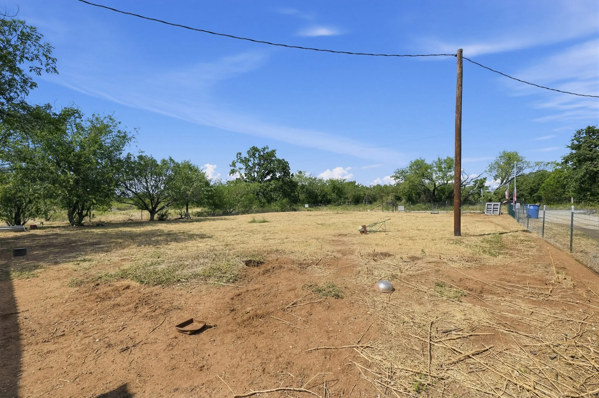 Expansive open land with perimeter fencing