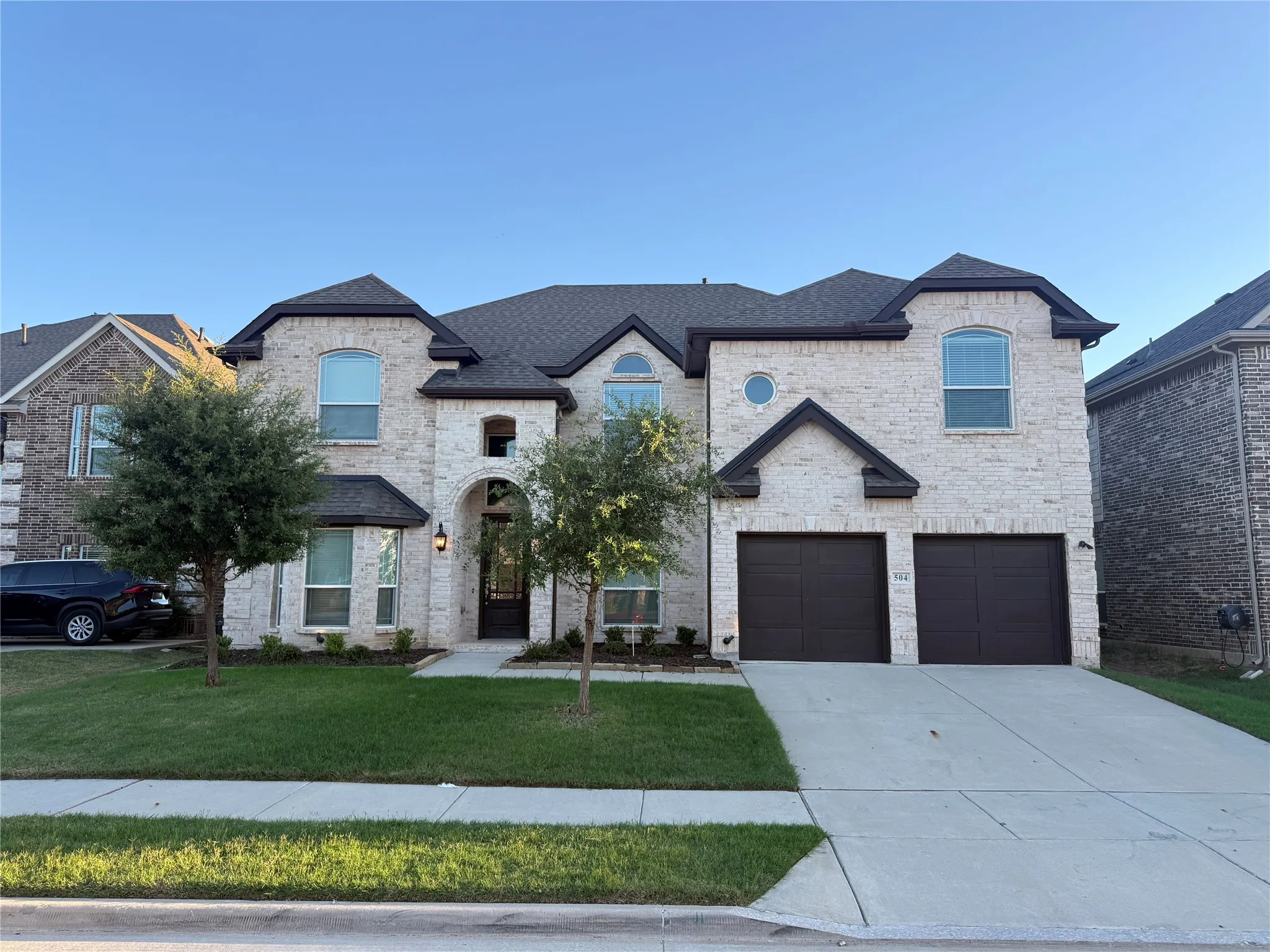 Light-toned stone facade with dark trim accents
