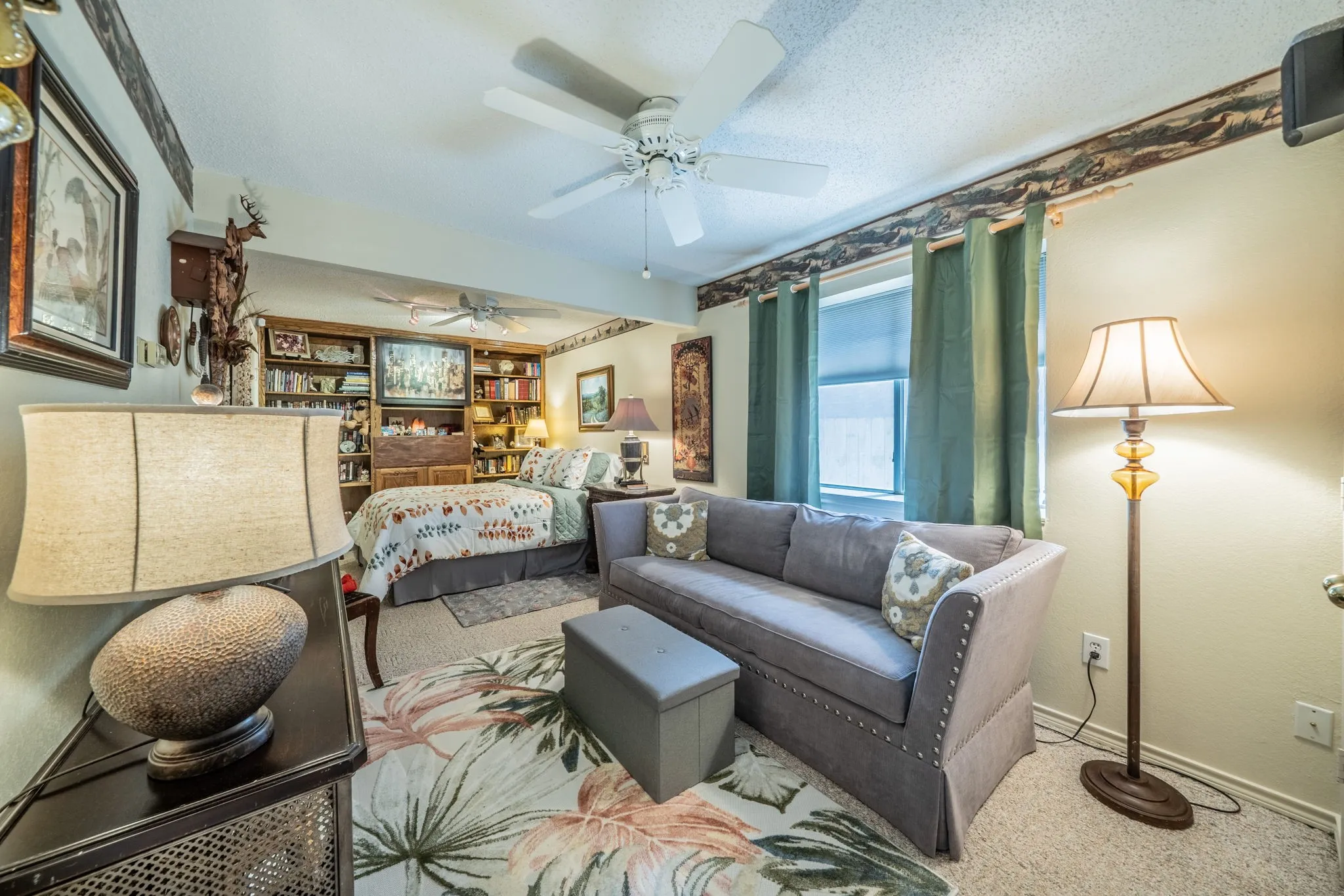 Built-in shelving, window with roller shade, 2 ceiling fans and also second door garage entry