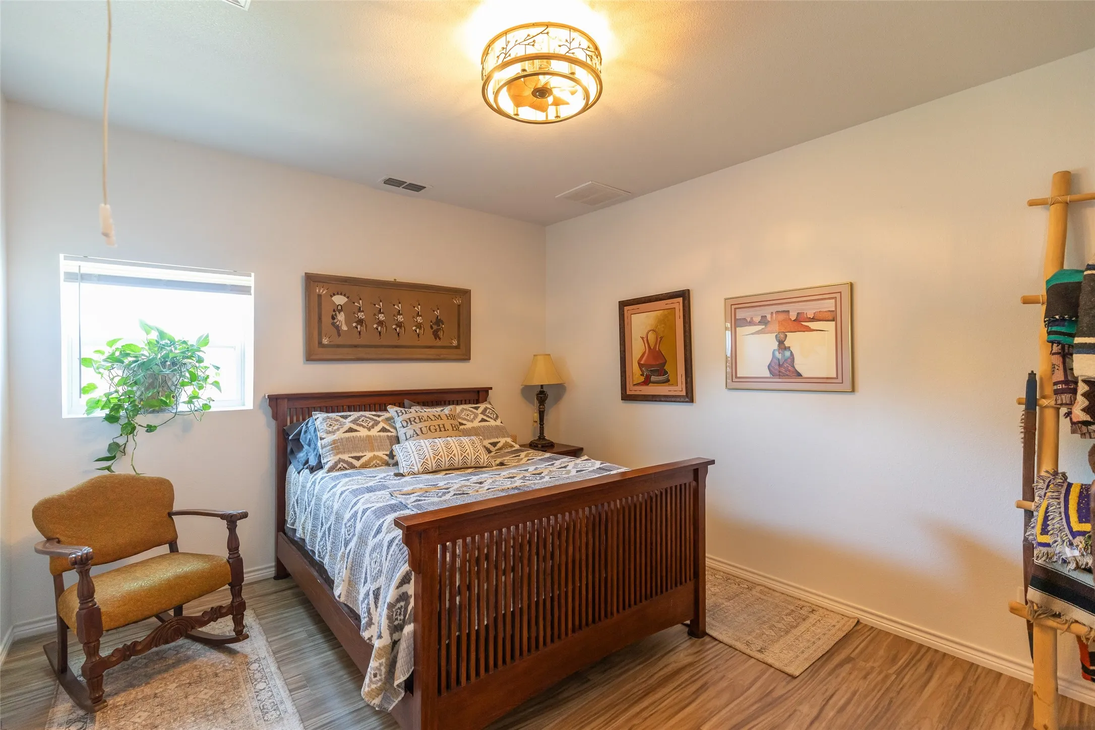 Wood-finish flooring, white walls, and a ceiling-mounted light fixture