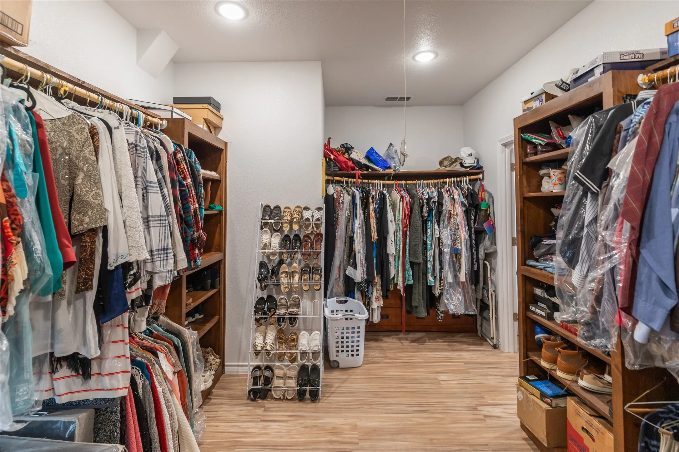Recessed lighting, wood-finish flooring, and built-in closet shelving