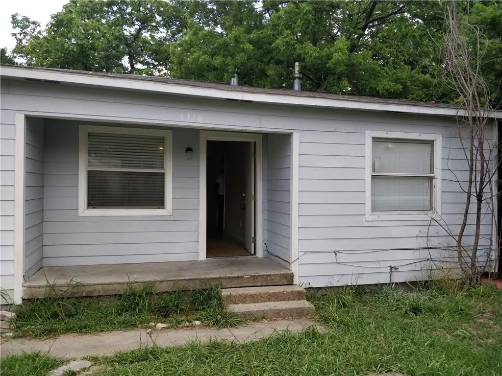 Light blue siding exterior with white trim and a covered entryway