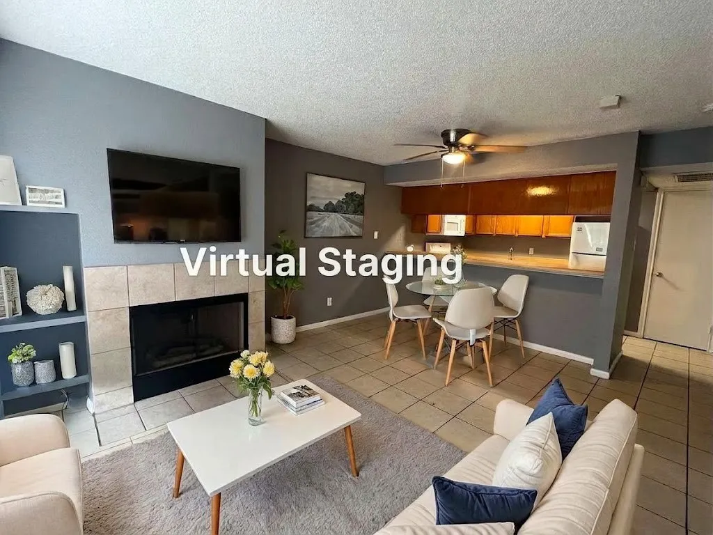 Tiled flooring throughout, fireplace with tile surround, built-in shelving, and a ceiling fan