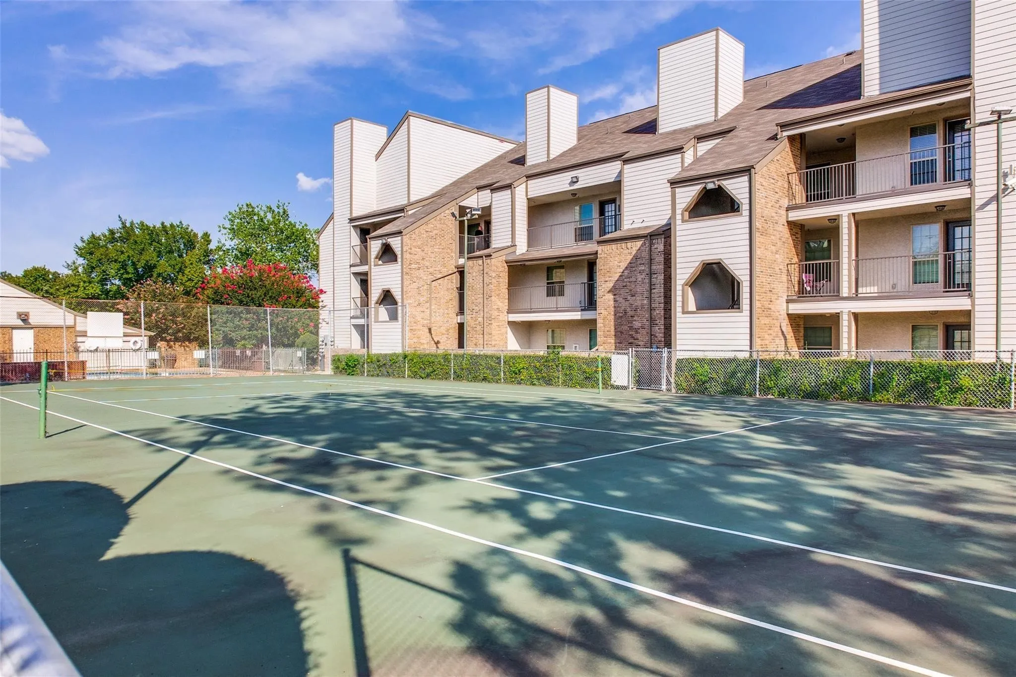 Hardscaped tennis court with painted lines and net