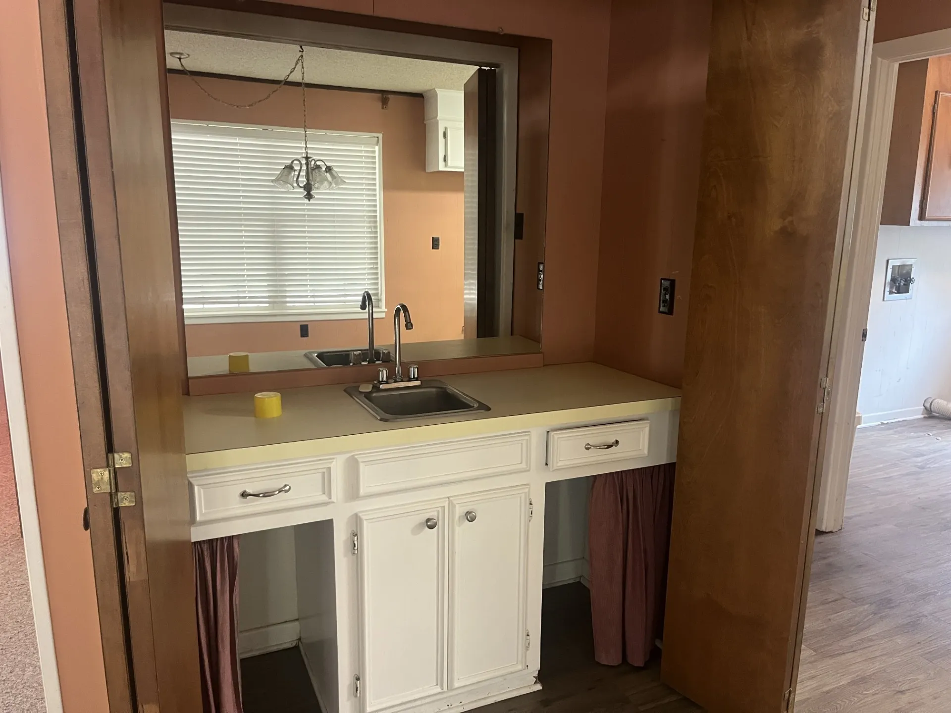 Built-in vanity with a single basin sink, chrome faucet, and integrated cabinetry