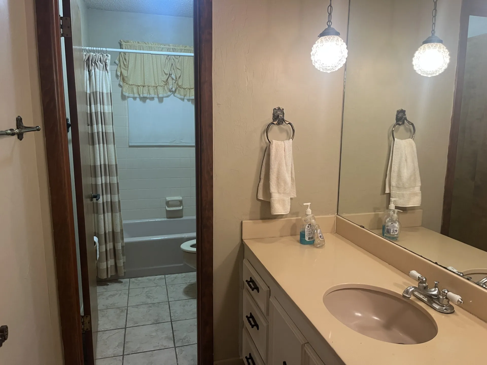 Vanity with a built-in sink and two pendant lights