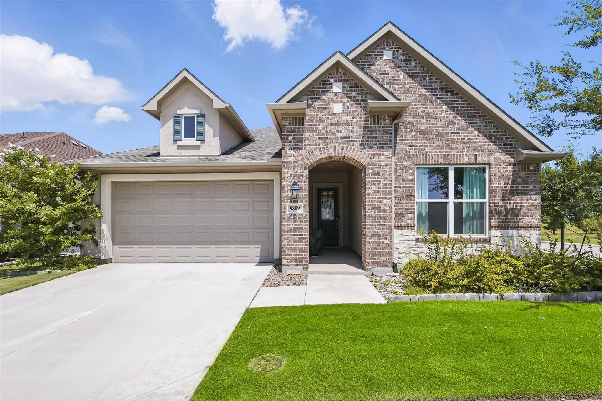 View of front of home with attached garage with epoxy flooring.