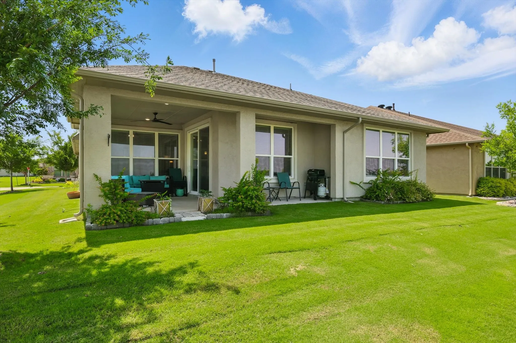 Rear view of property with patio area, and lawn