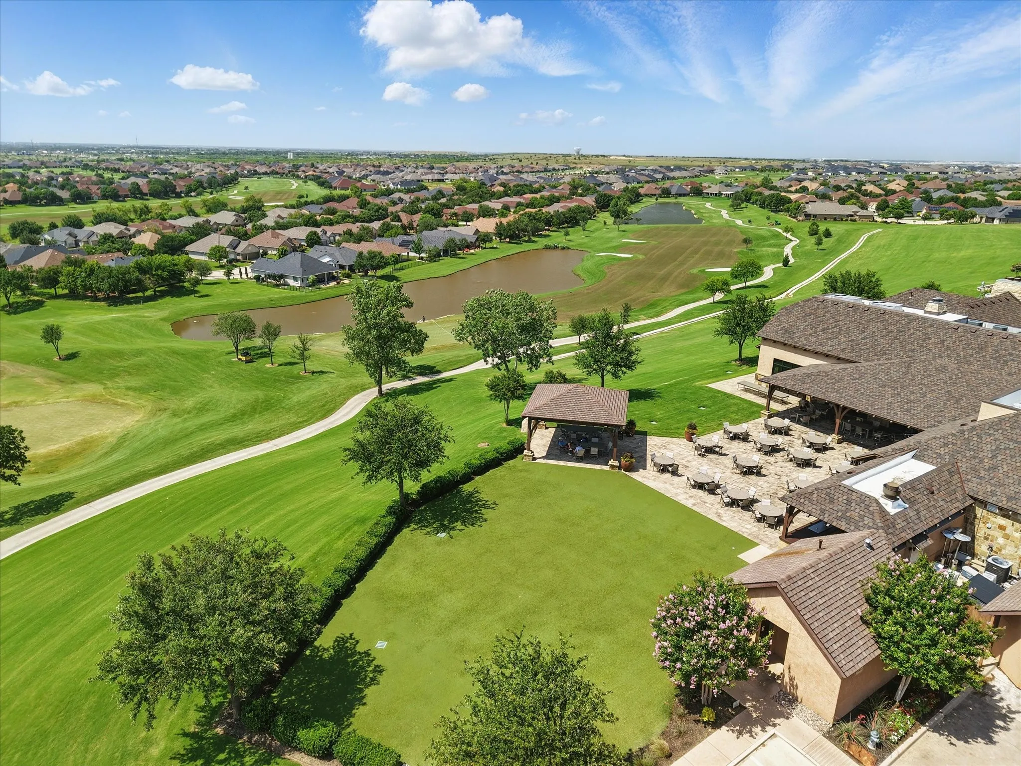 Aerial view of patio area and golf course behind the Wild Horse Grill, lounge, and bar.