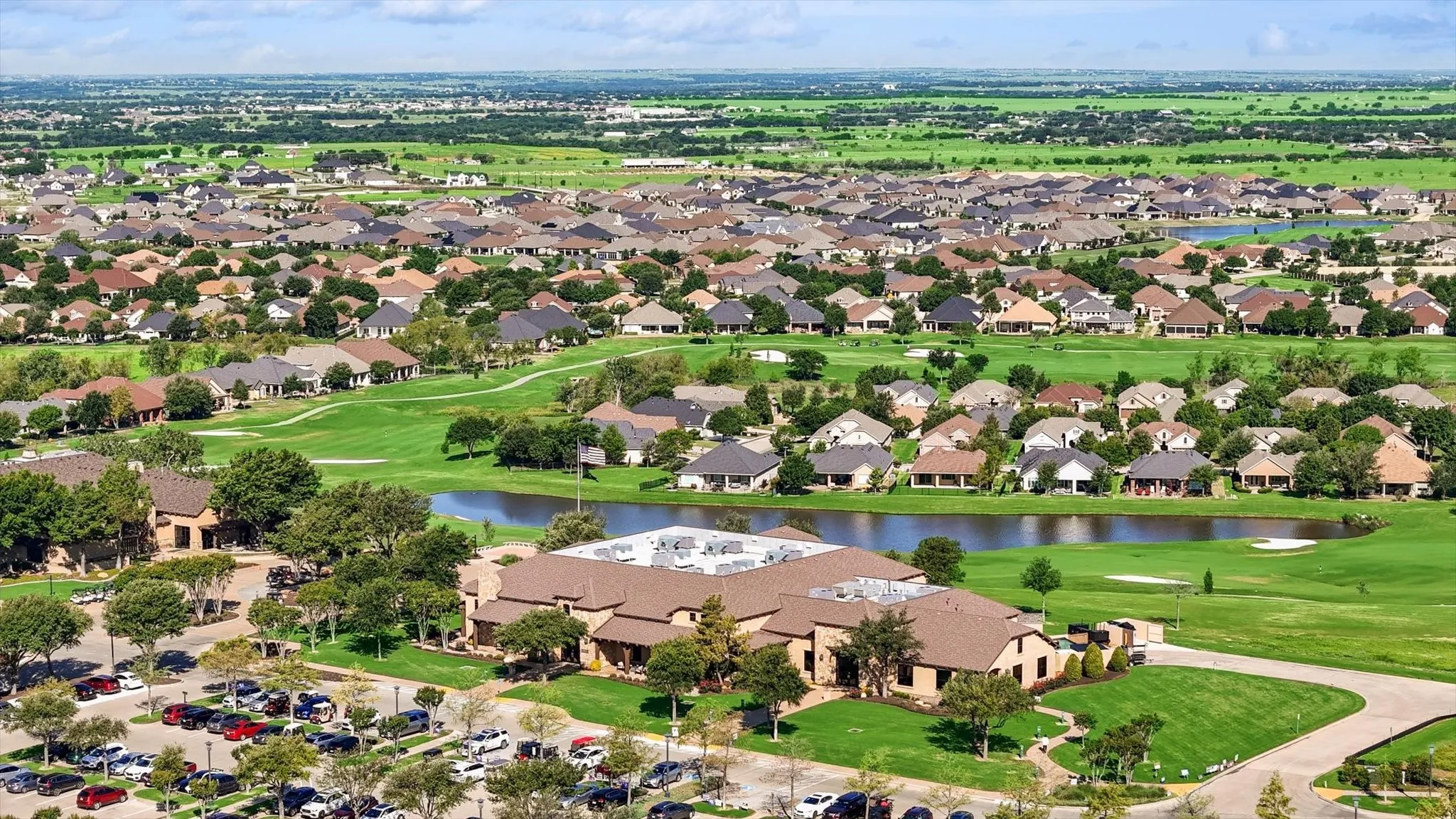 Aerial view of Clubhouse and pond on golf course.