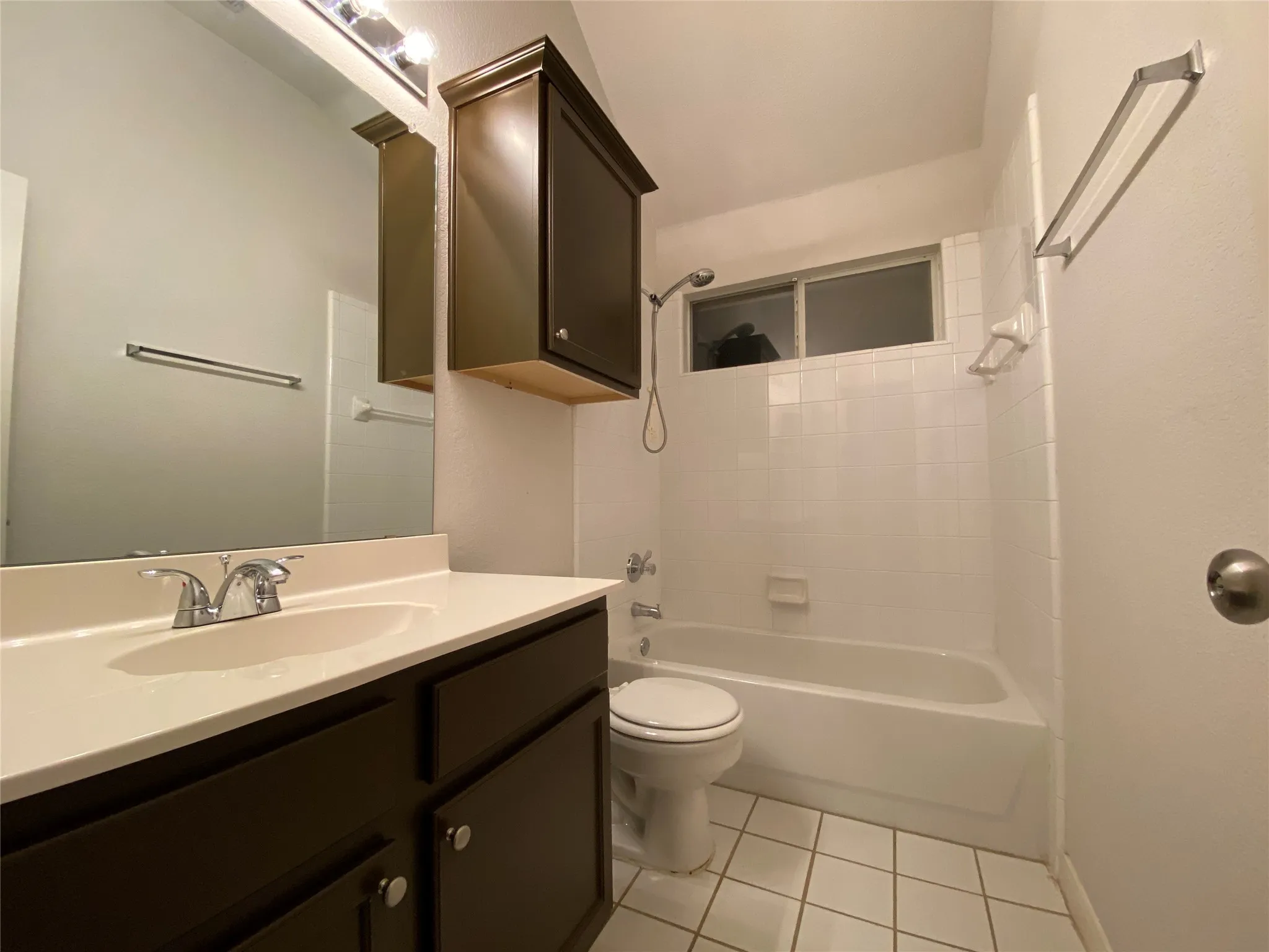 Full bathroom with tile patterned floors, vanity, shower / bathtub combination, and toilet