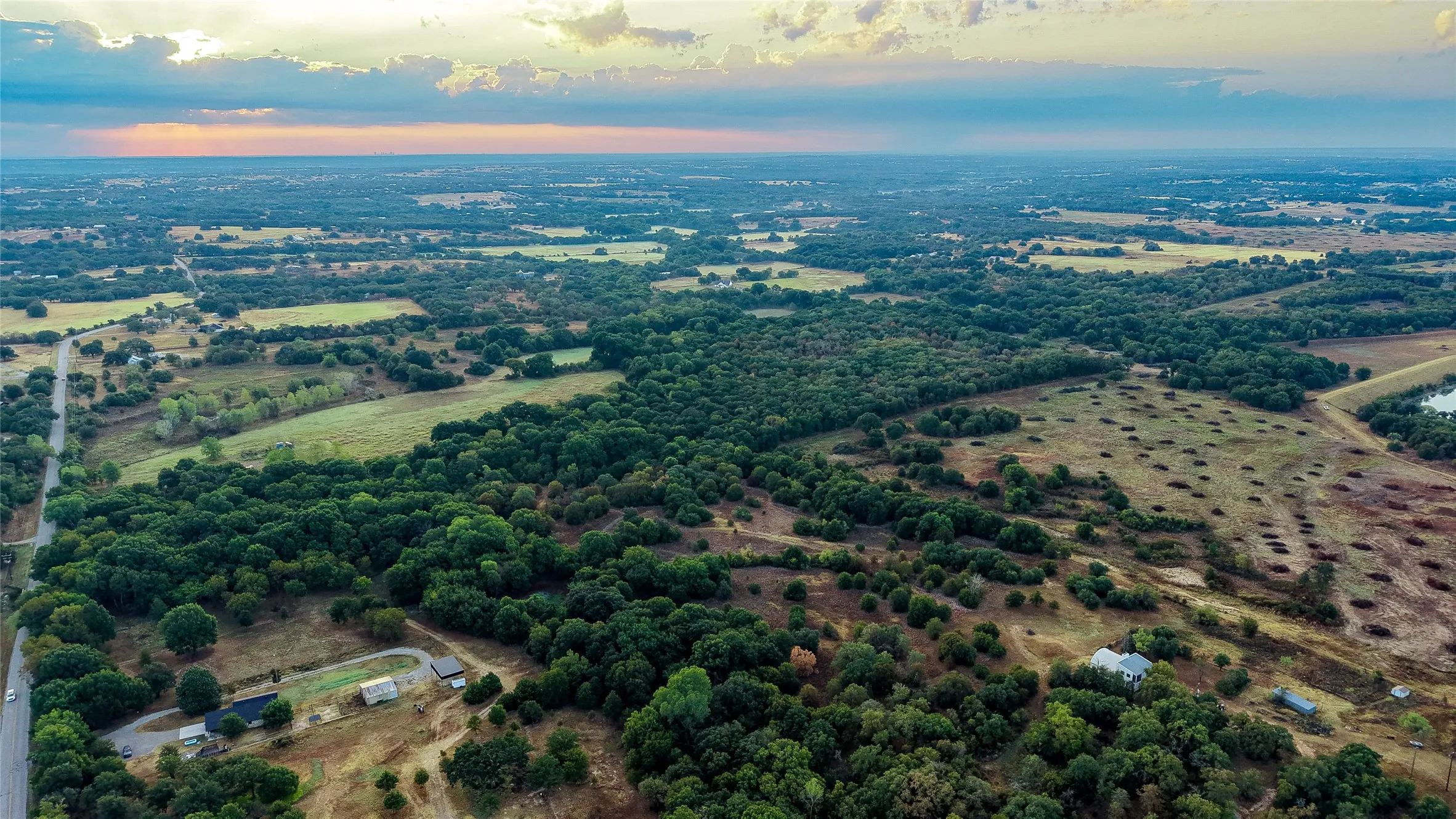 Expansive acreage featuring mature tree lines and open fields