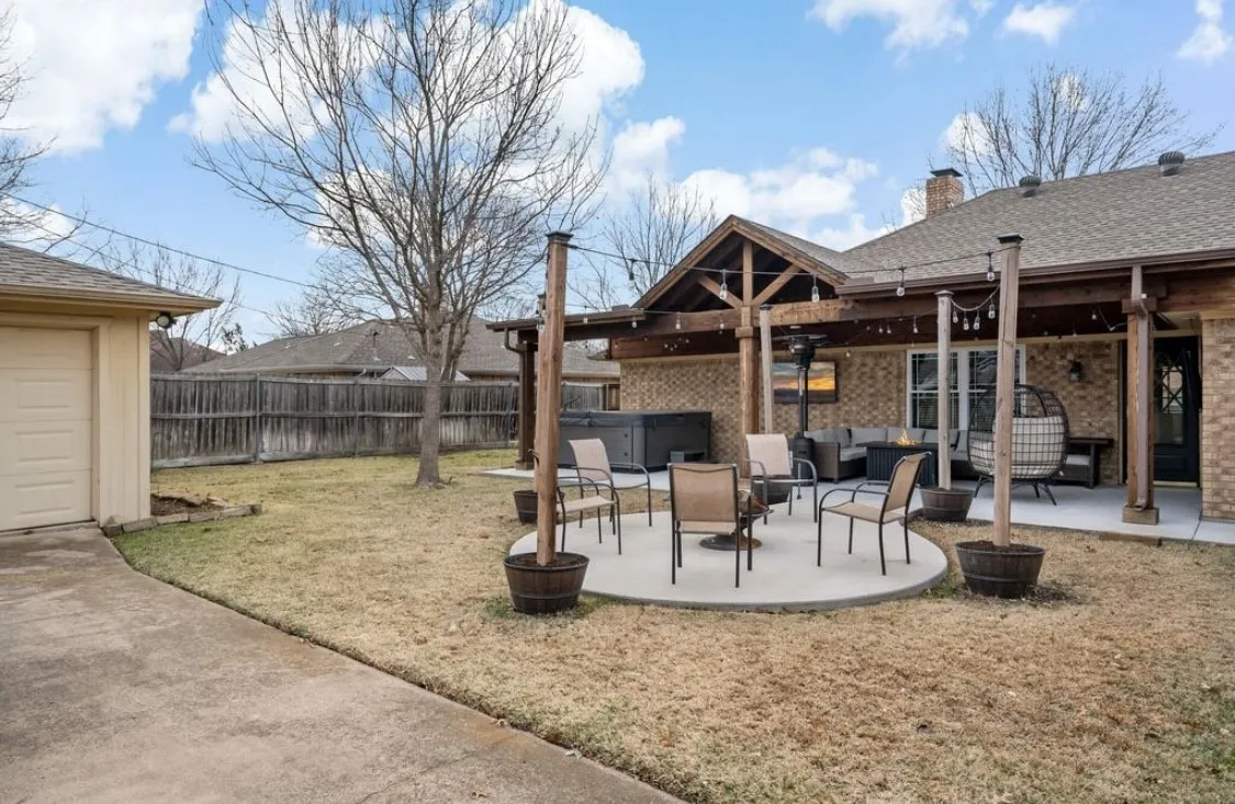 View of yard with a hot tub, outdoor lounge area, a fenced backyard, and a patio