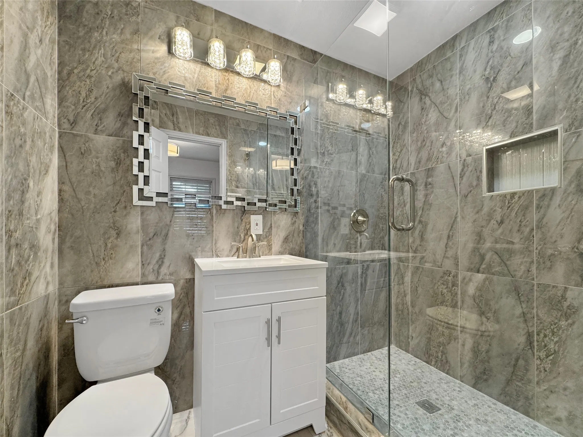 Floor-to-ceiling tile in the shower and vanity area
