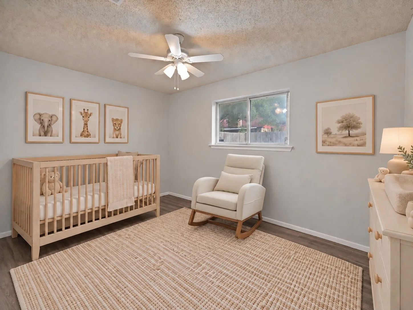 Secondary bedroom: Window overlooking the backyard and ceiling fan. Virtually staged.