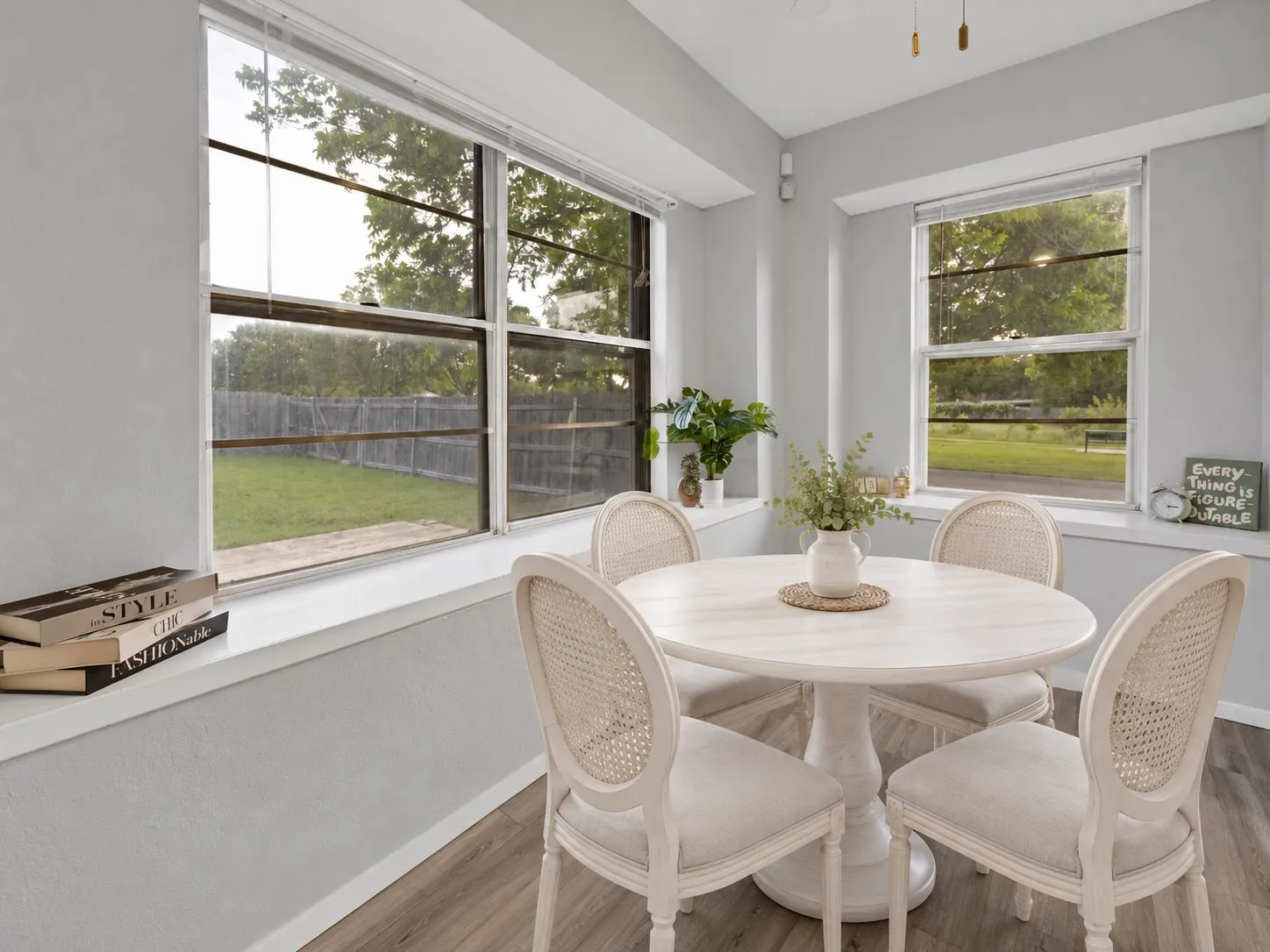 Breakfast nook: Breakfast area with two windows, deep window ledges, and wood-look plank flooring. Views of the fenced backyard and front green space. Virtually staged.