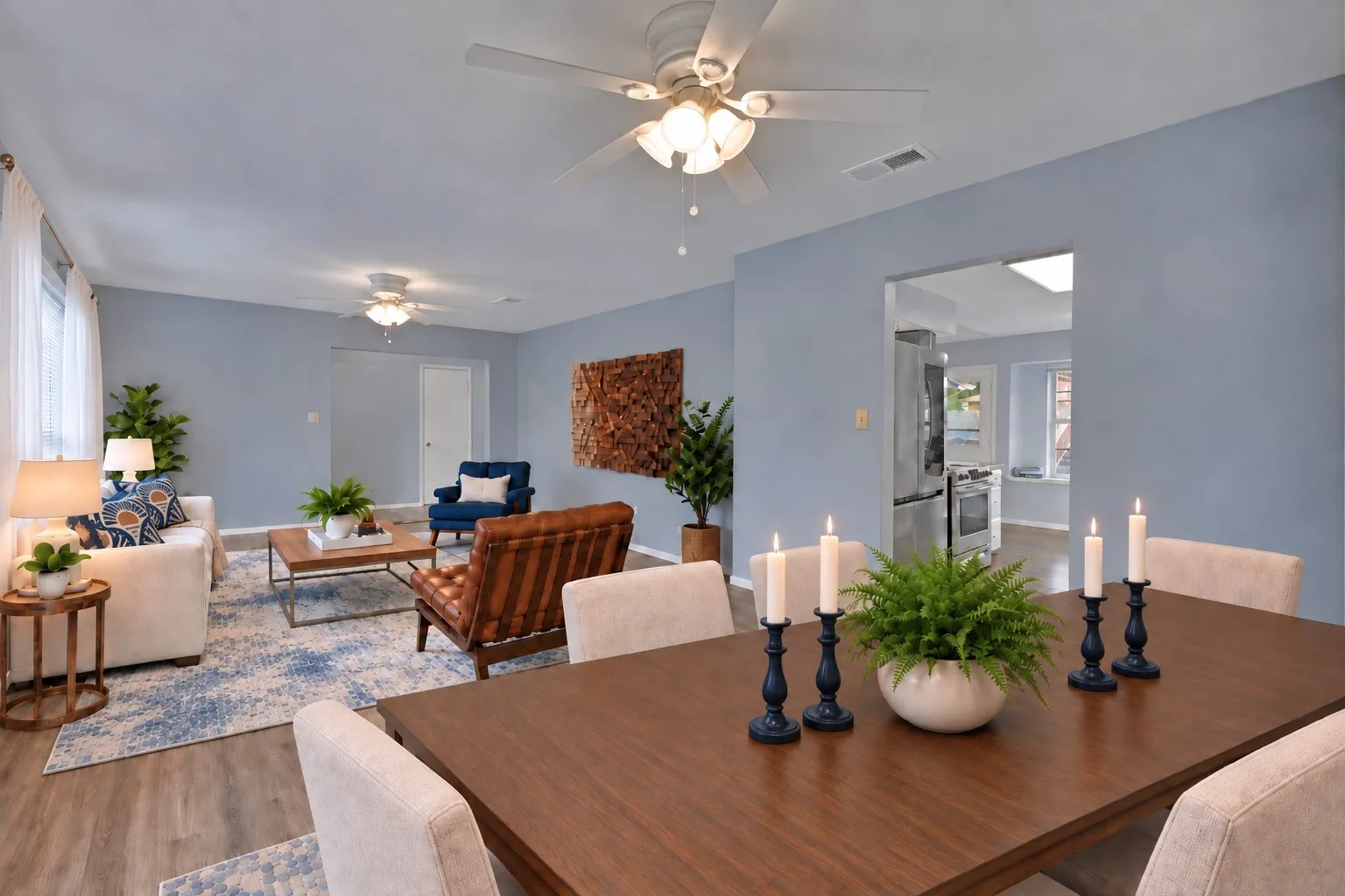 Dining and living: Dining area flows into the front living room with kitchen access through a cased opening. Virtually staged.