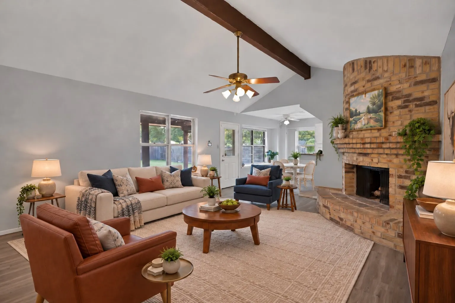 Family room: Windows overlooking the covered back patio with sightline to the breakfast area and kitchen. Virtually staged.