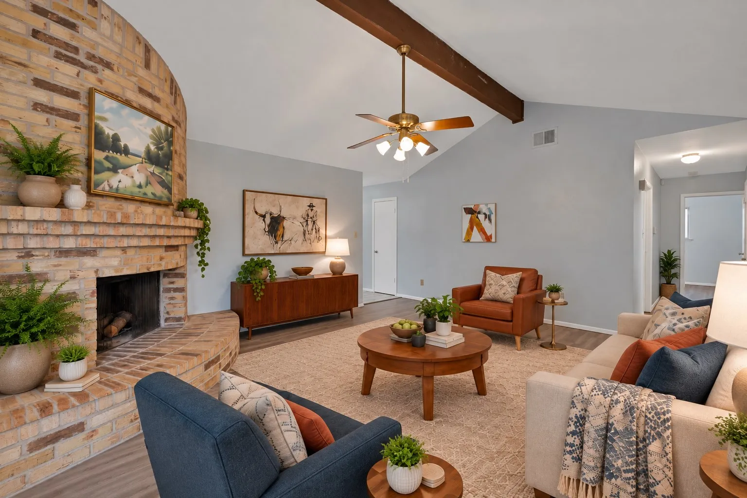 Family room: Vaulted ceiling with exposed wood beam and corner brick fireplace with raised hearth and mantel. Windows overlook the back patio with open flow to the breakfast area. Virtually staged.