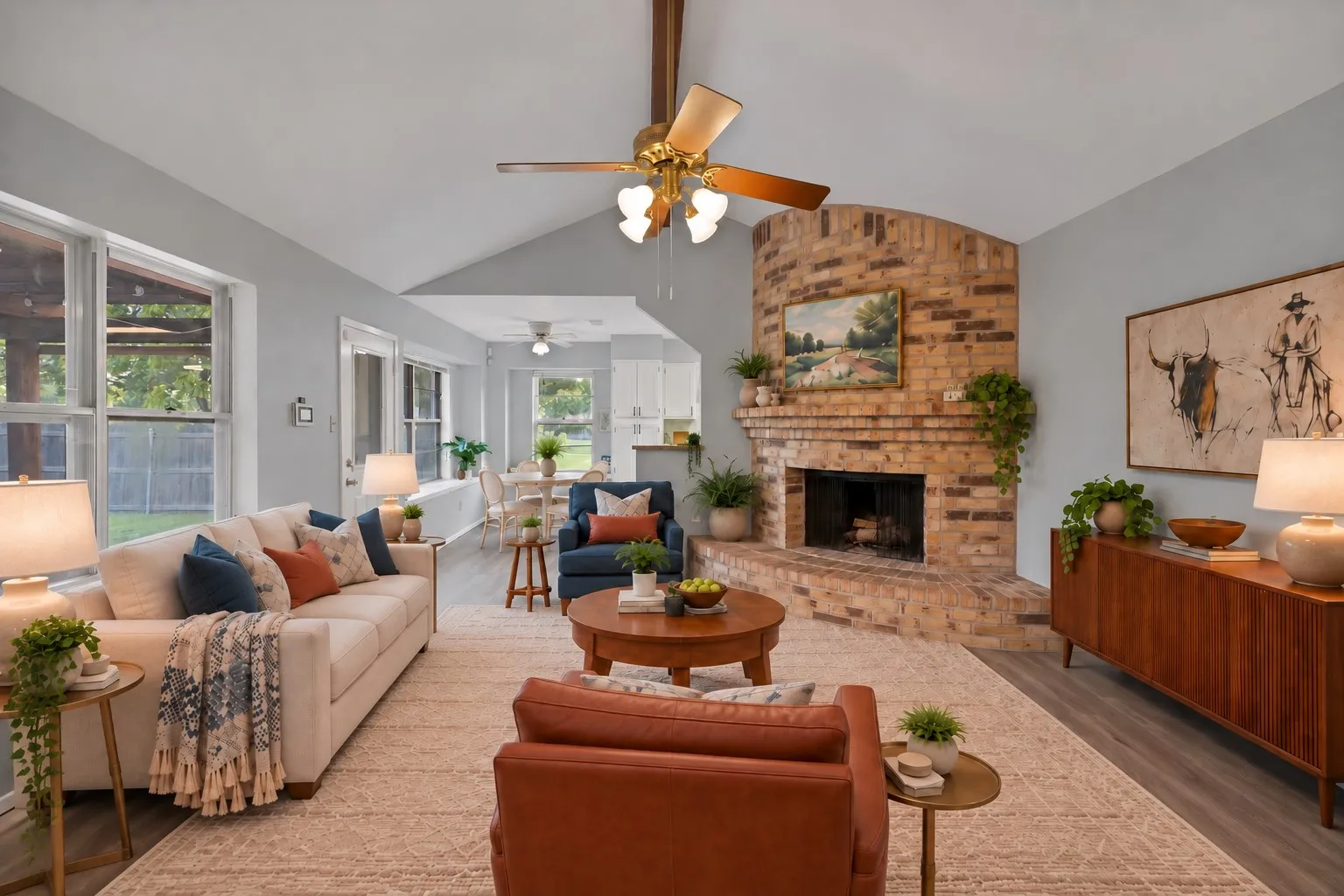 Family room: Vaulted ceiling with exposed wood beam and corner brick fireplace with raised hearth and mantel. Back door to the yard and open flow to the breakfast area. Virtually staged.
