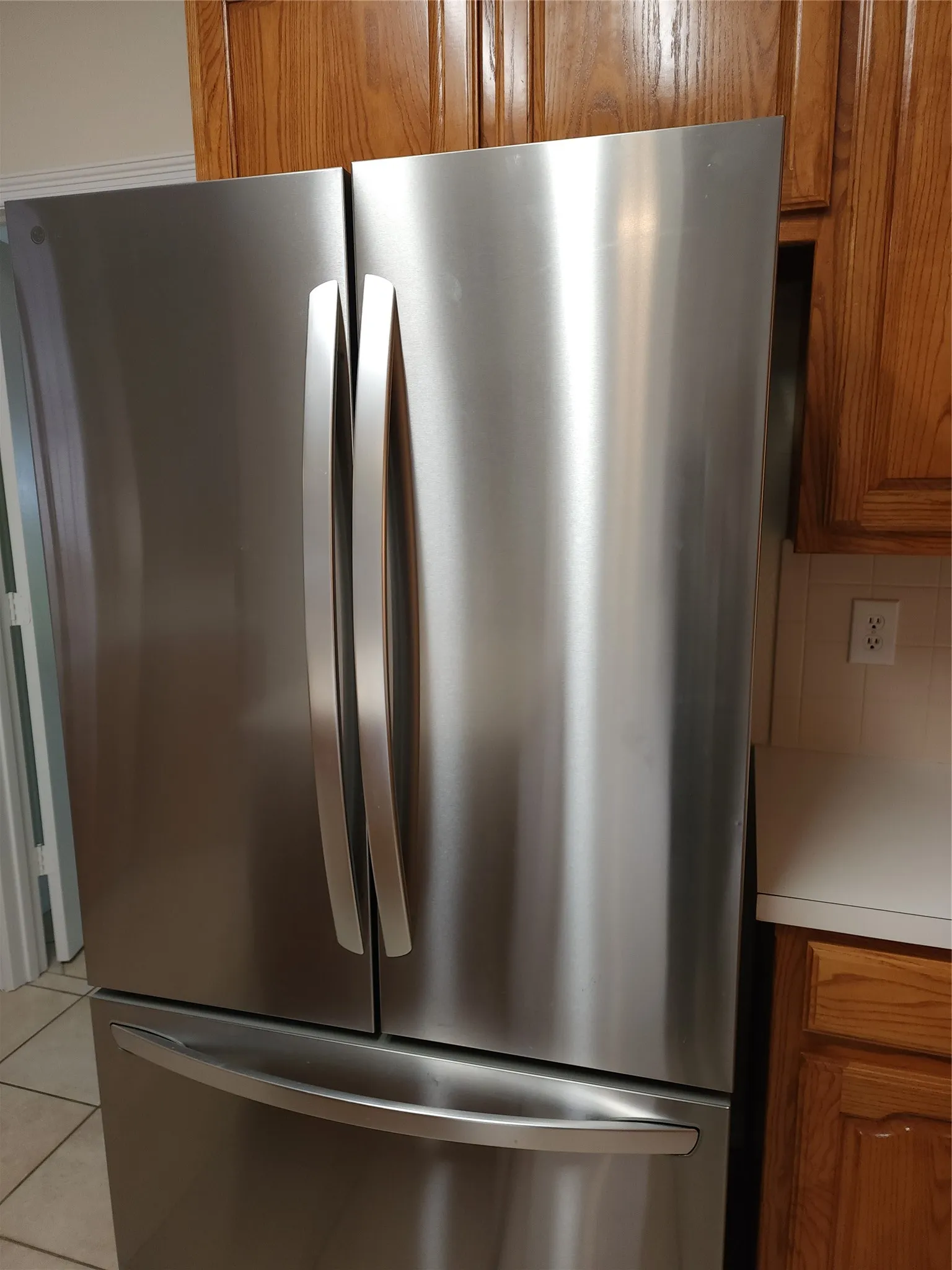 Refrigerator with pull out freezer drawer