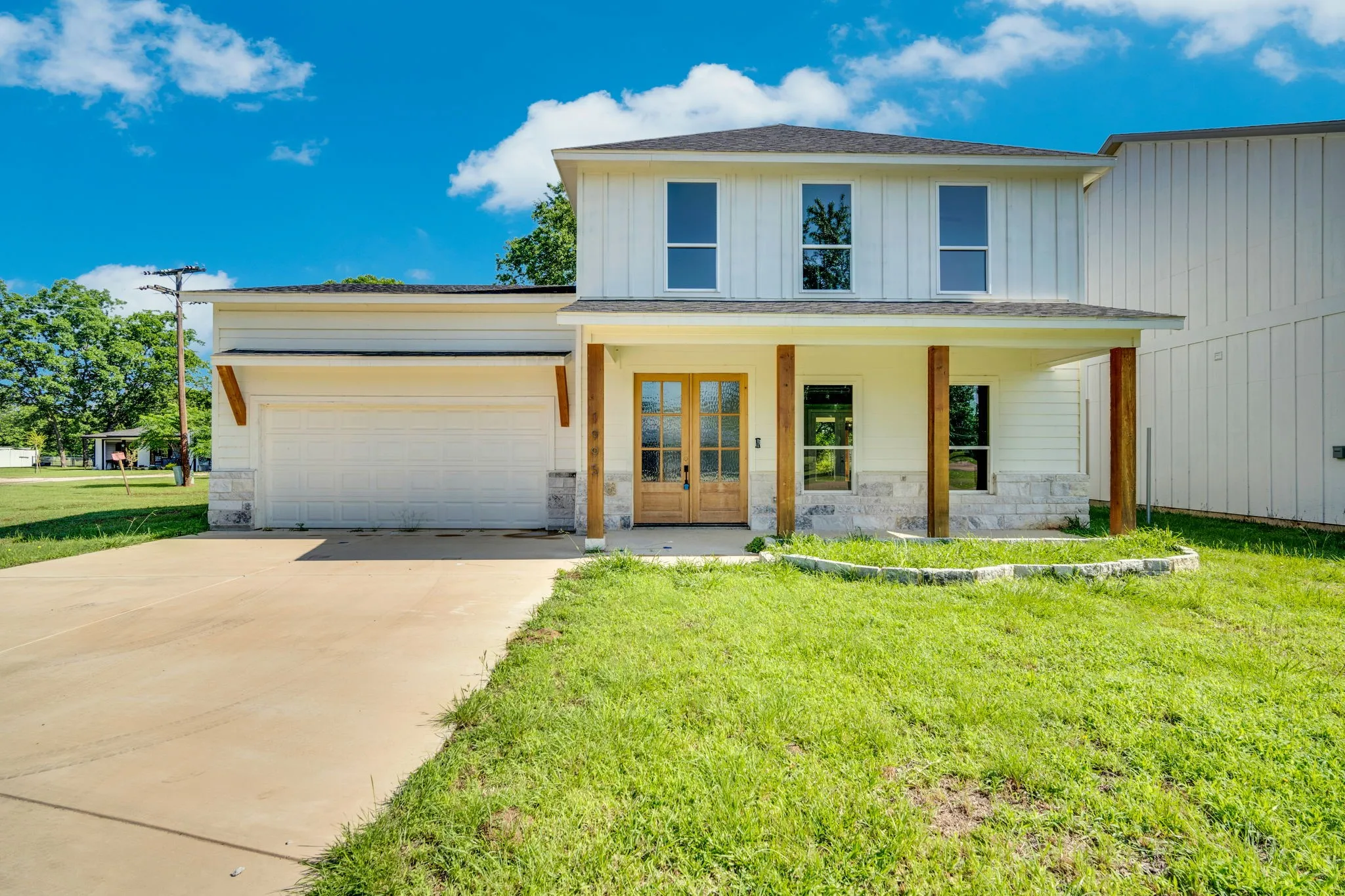 Two-story exterior with vertical siding and stone accents
