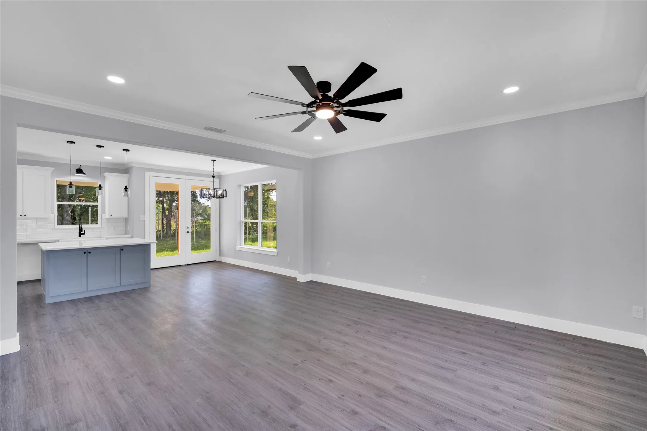 Spacious interior featuring wood-finish flooring, recessed lighting, and a contemporary ceiling fan